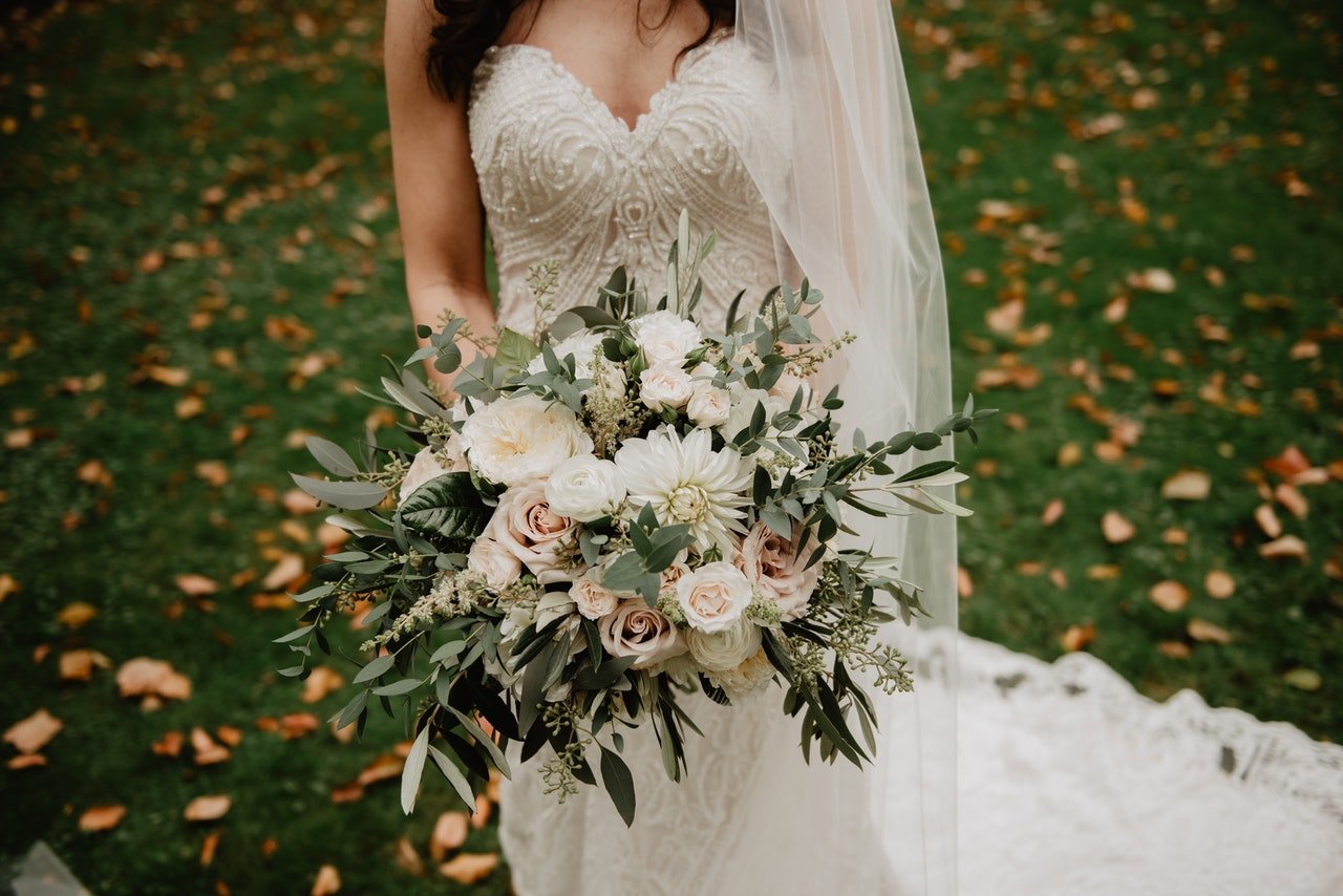 Woman in wedding gown with flower bouquet | Source: Pexels