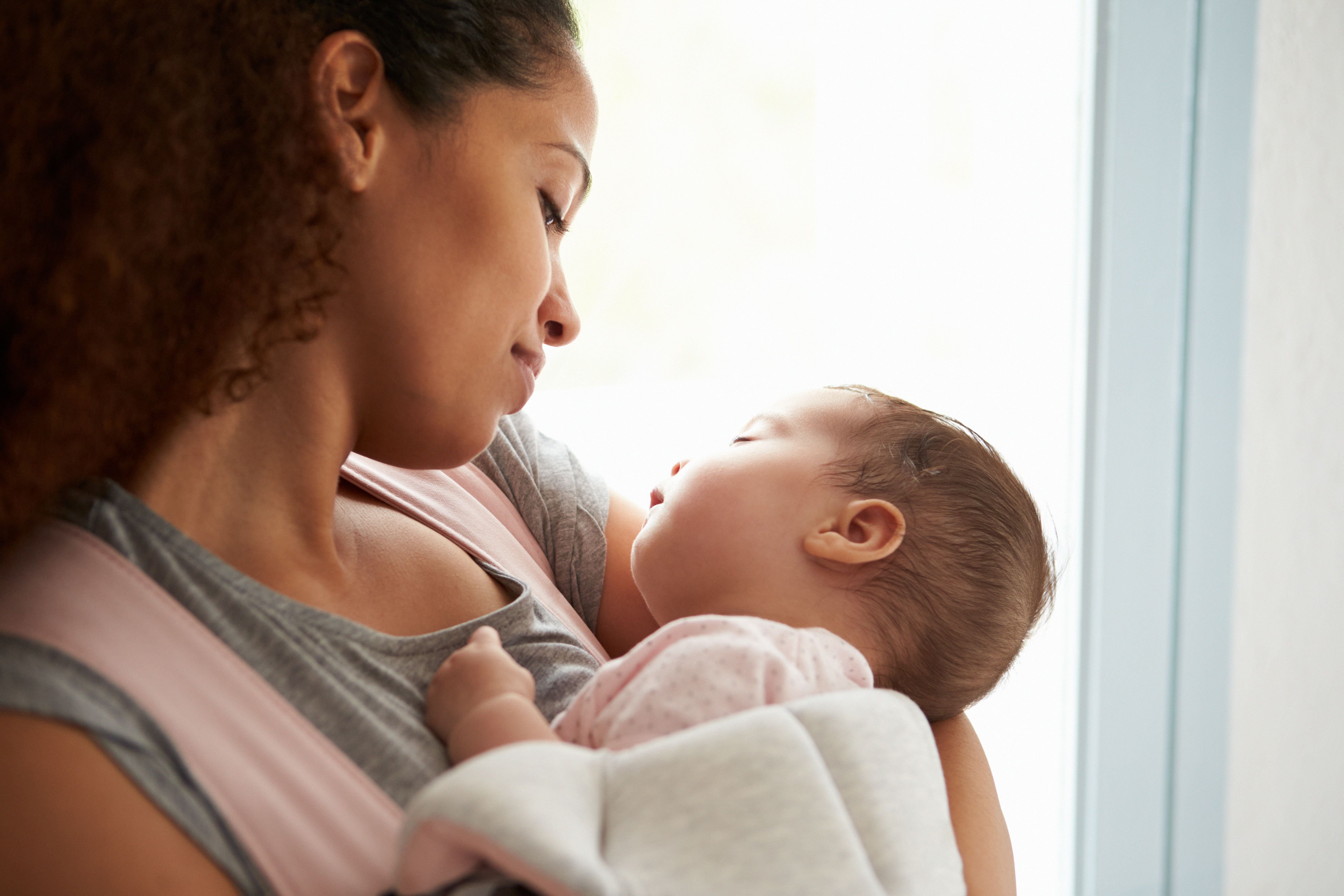 A mother cradling her baby. | Source: Shutterstock