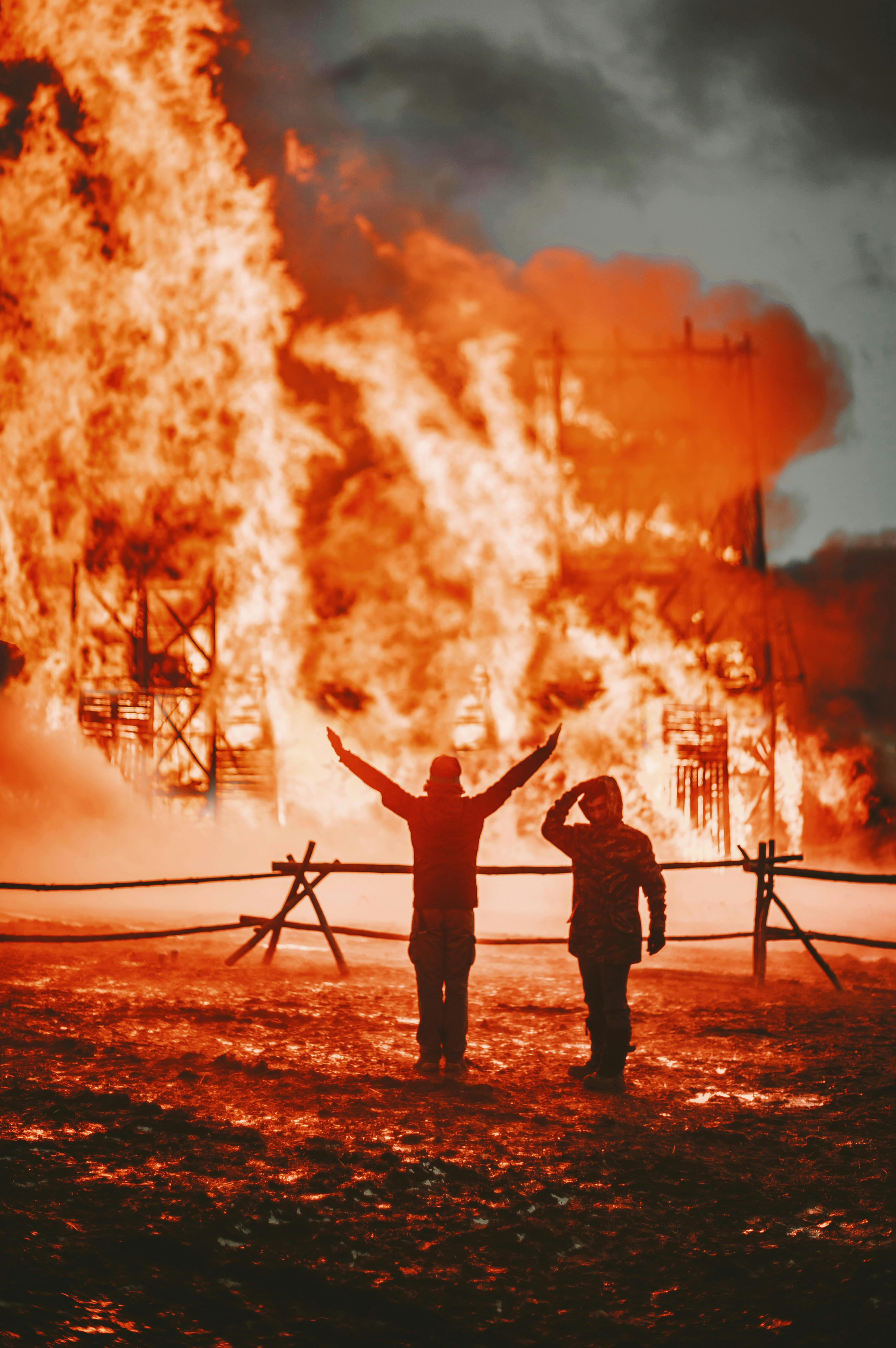 Firemen by a building on fire | Source: Pexels