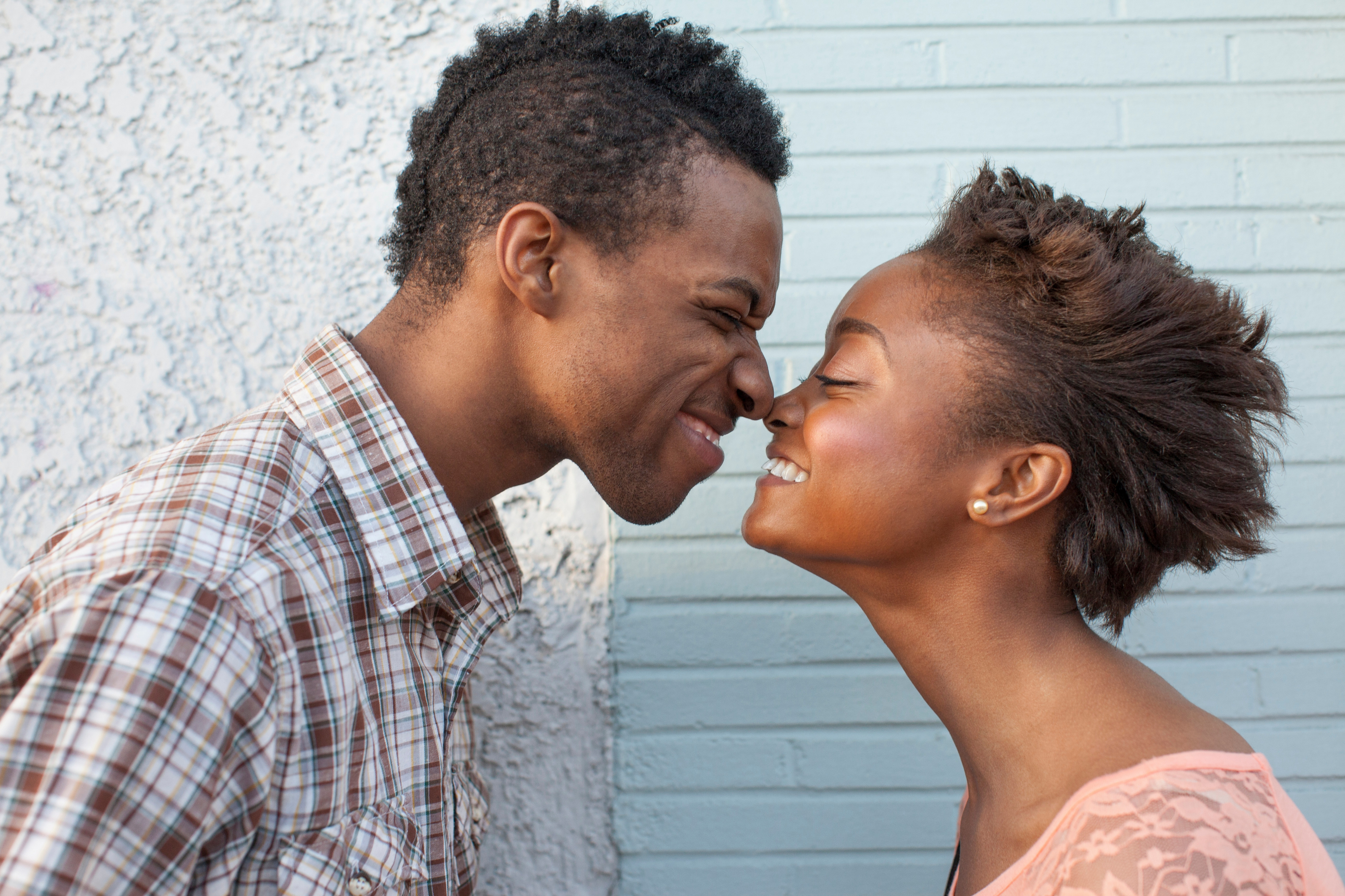 Young couple touching noses | Source: Getty Images