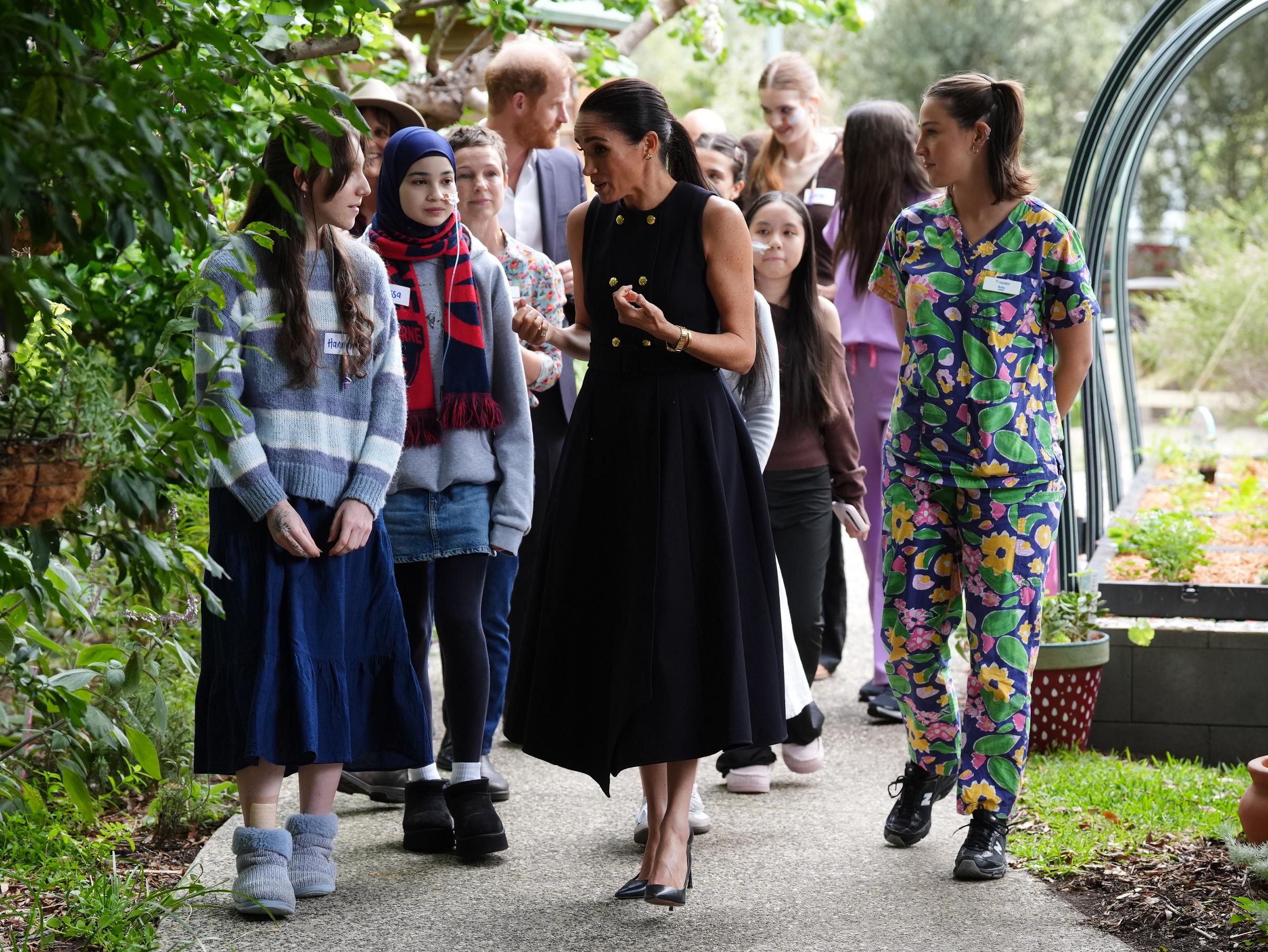 Meghan walks with adolescent patients and staff in the Kelpie garden on a visit to the Royal Children's Hospital with her husband Prince Harry, Duke of Sussex on April 14, 2026 in Melbourne, Australia. | Source: Getty Images