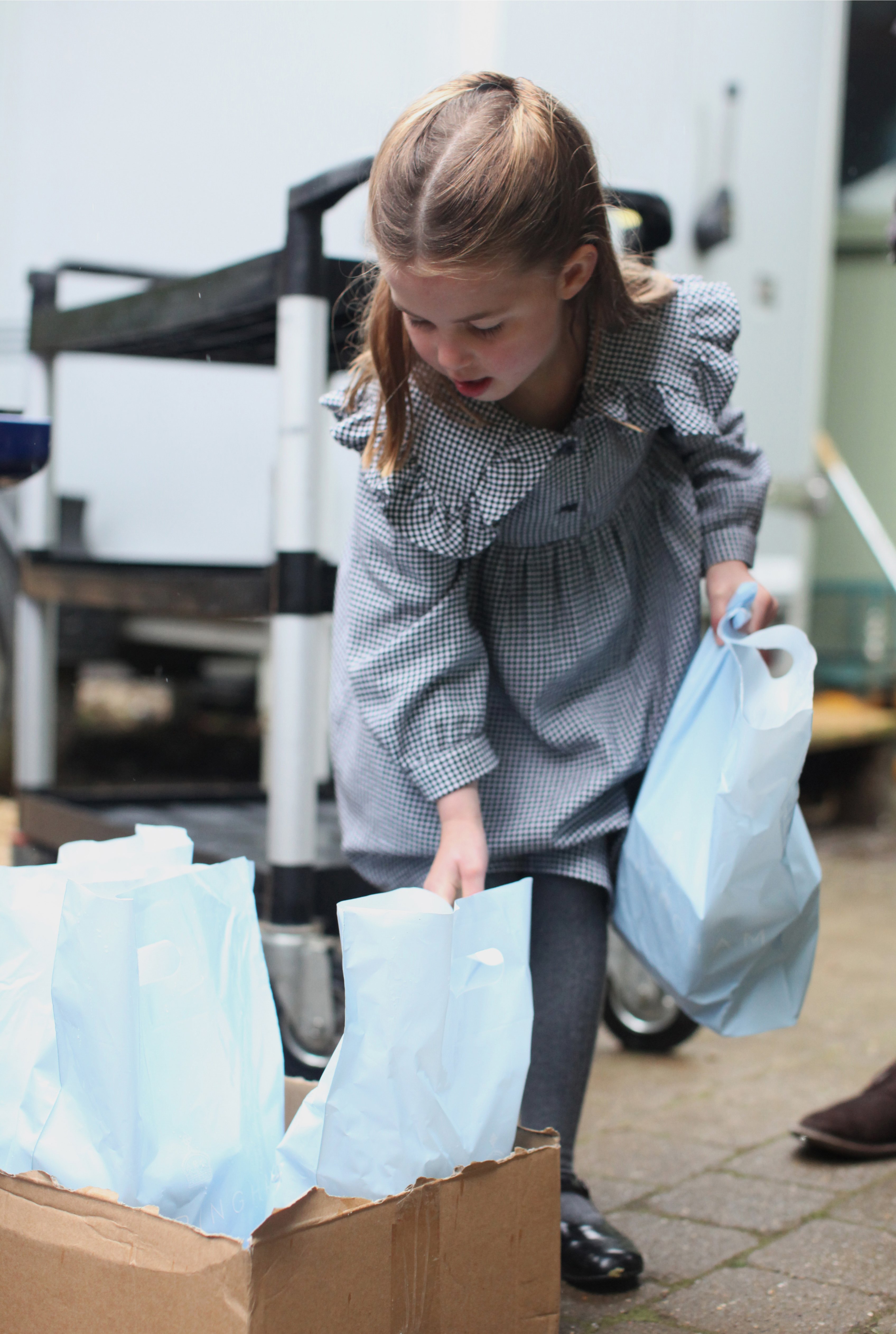 Princess Charlotte photographed picking up packages. | Source: Getty Images