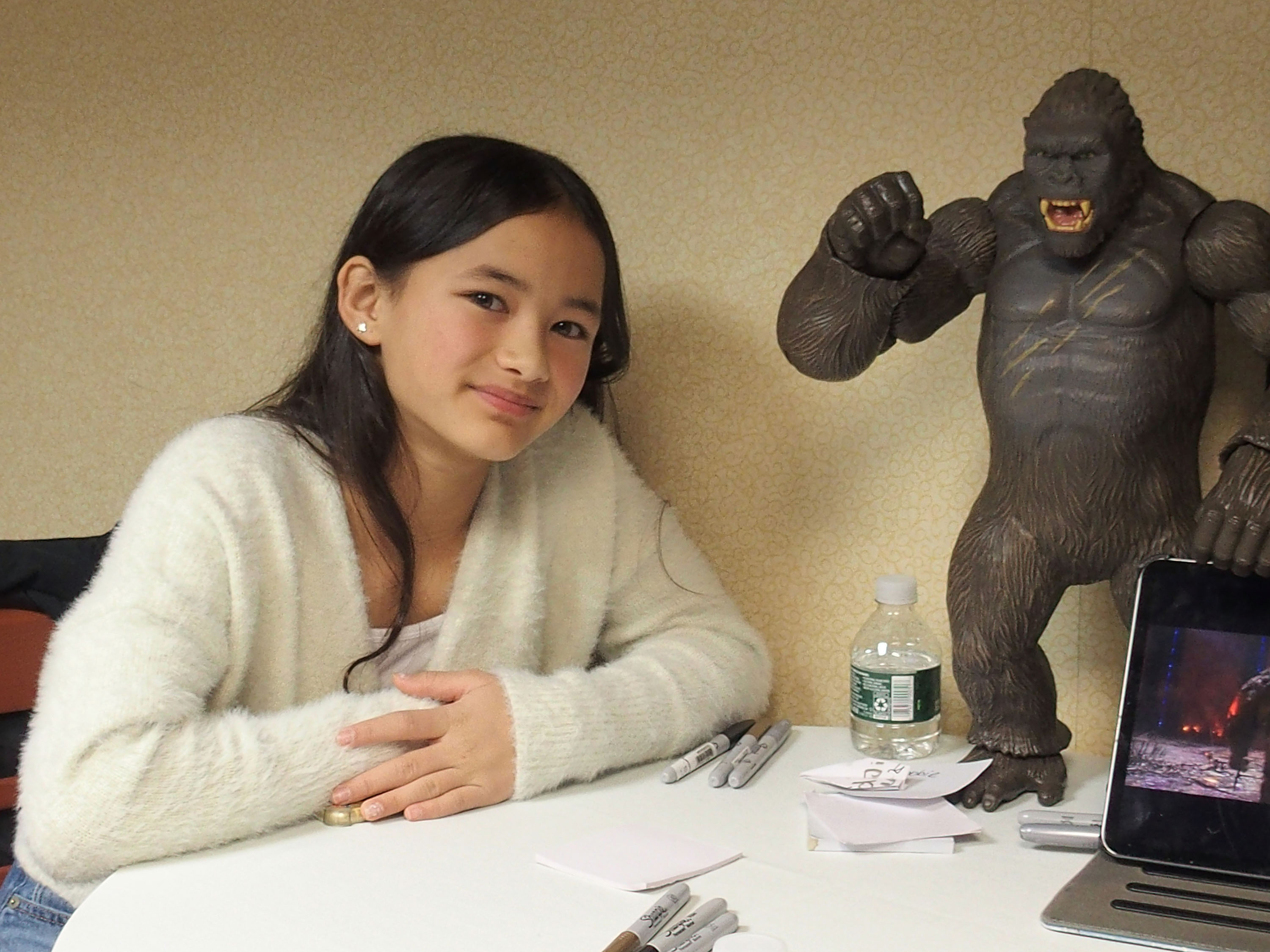 Kaylee Hottle poses beside a King Kong figure during the 2021 Northeast Comic Con & Collectibles Extravaganza in Boxborough, Massachusetts. The appearance came months after the release of "Godzilla vs. Kong," the film that launched her acting career. | Source: Getty Images