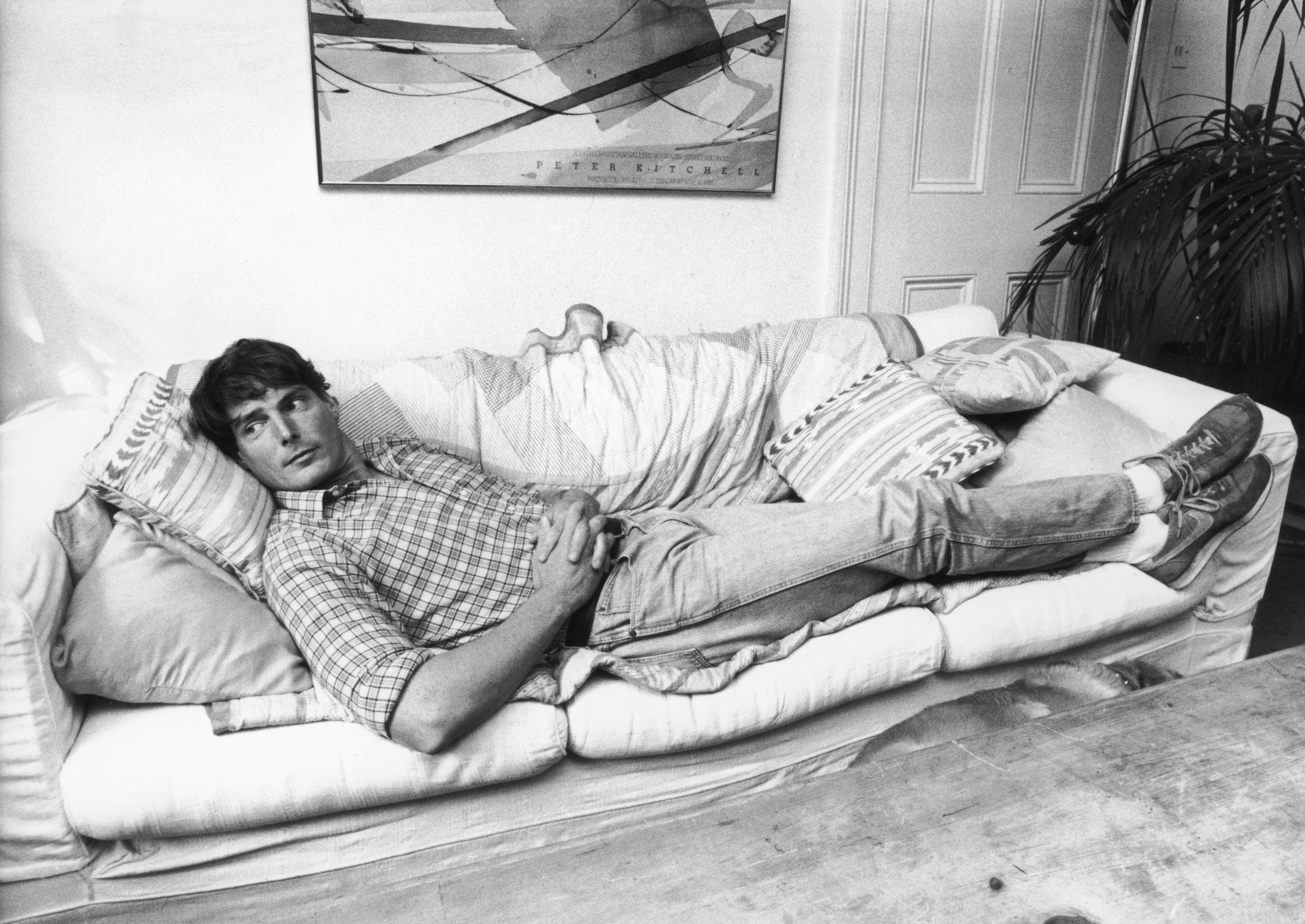Director and activist Christopher Reeve pictured laying down on a couch in 1986. / Source: Getty Images