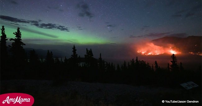 Incredible footage captured of the northern lights dancing over forest wildfires