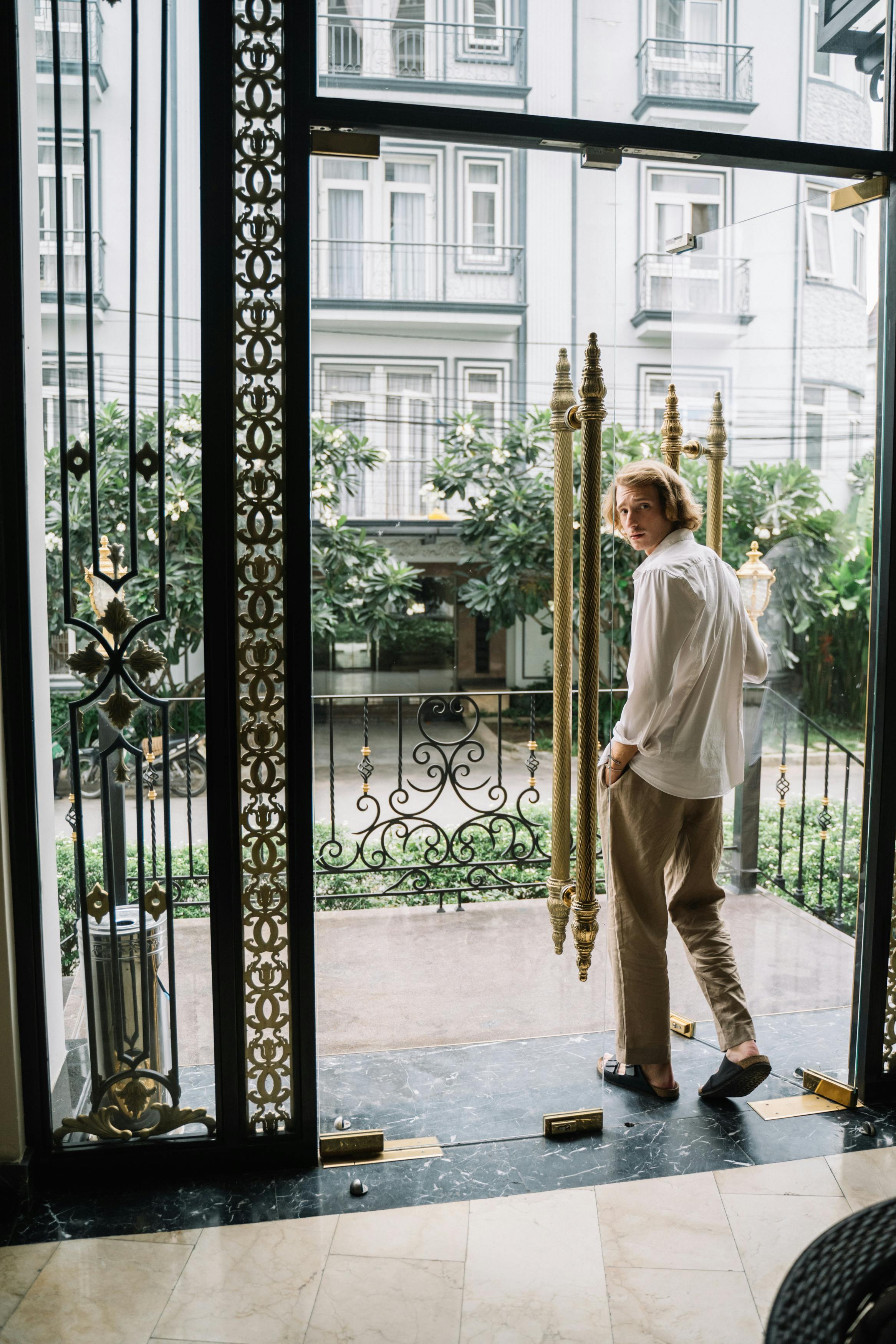 A man looking back while walking through a door | Source: Pexels