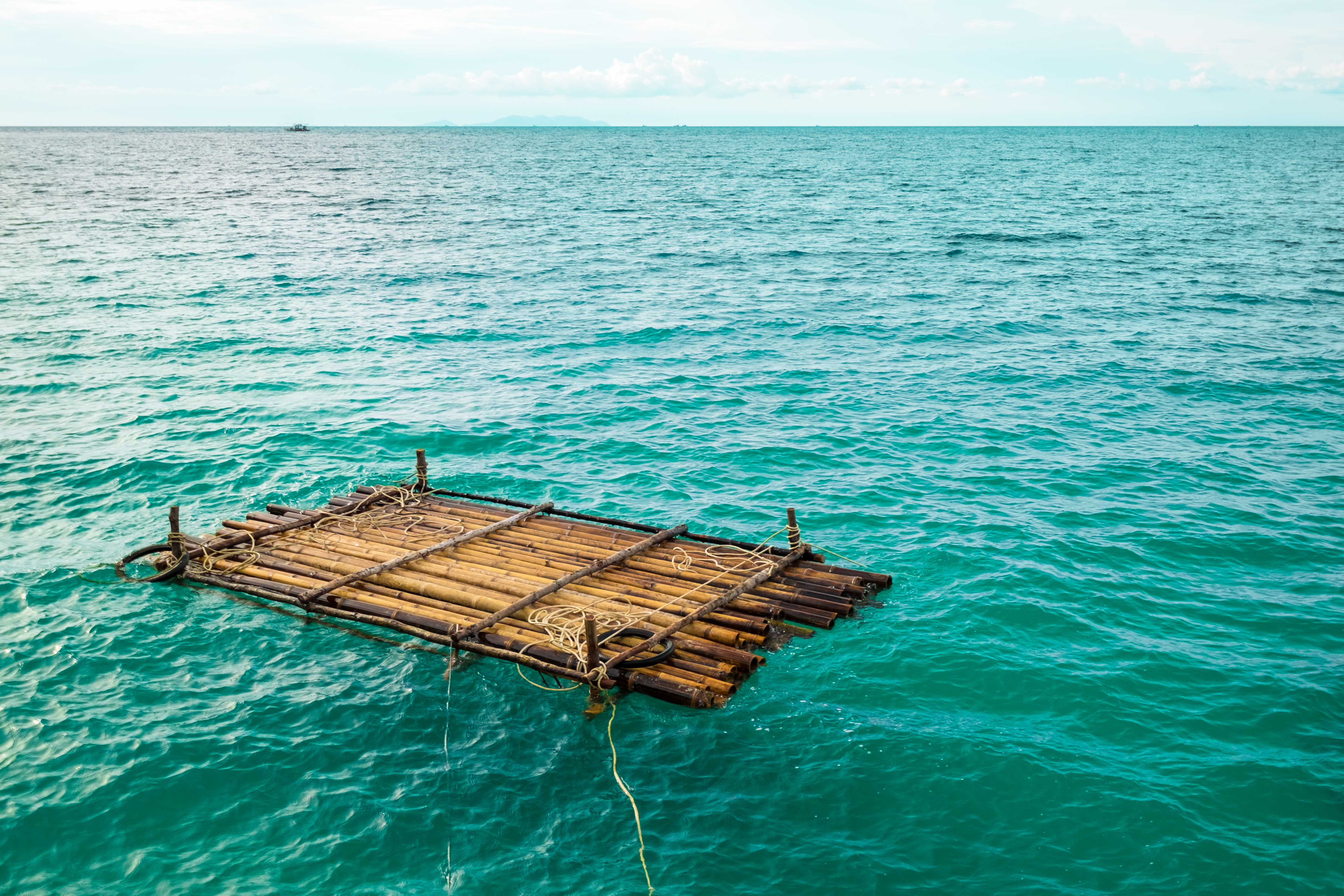 Wooden raft is floating in water. | Source: Shutterstock
