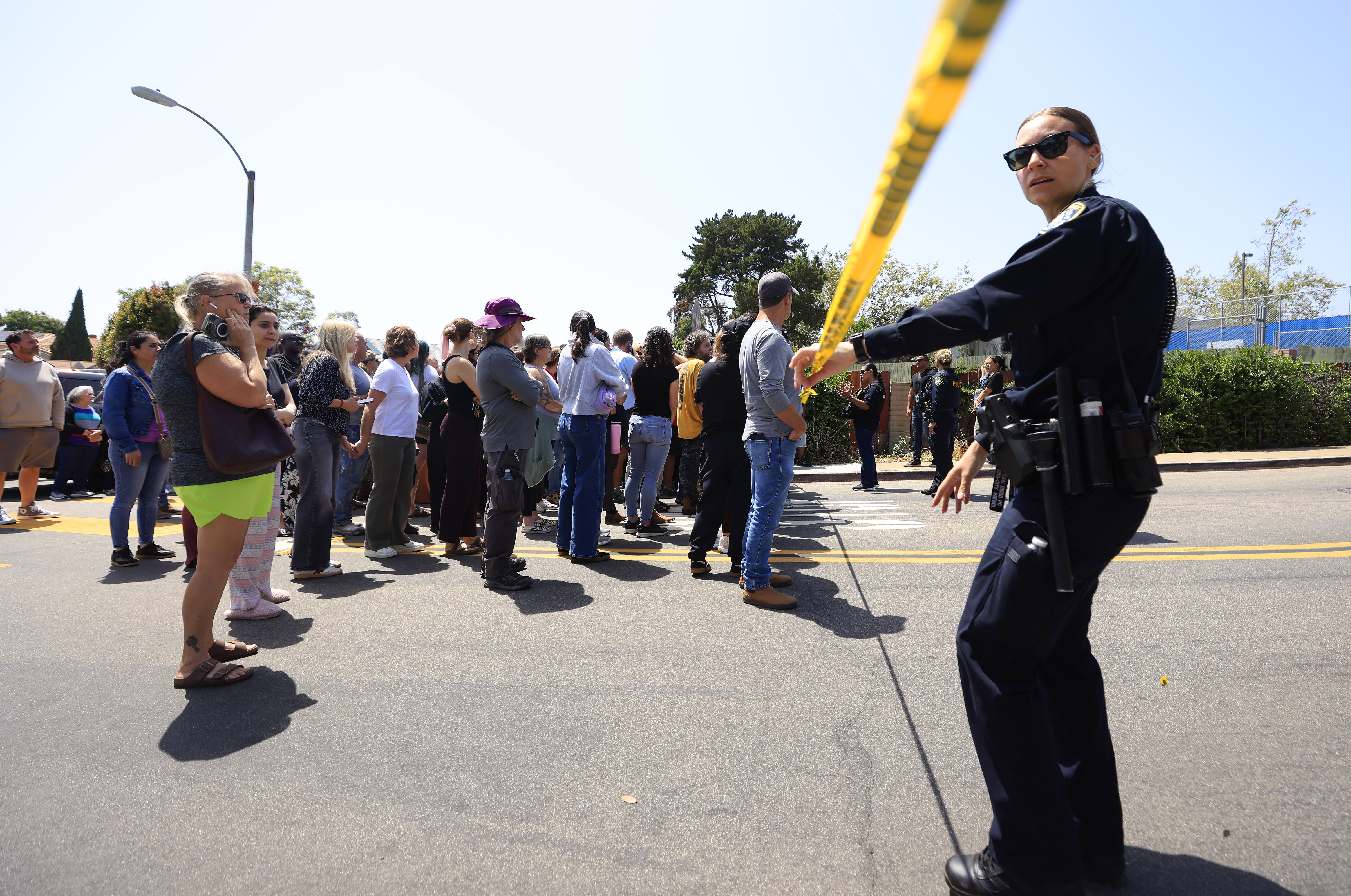 Parents of students at Kavod Charter School wait to be reunited after a shooting at the nearby Islamic Center of San Diego on May 18, 2026, in San Diego, California | Source: Getty Images