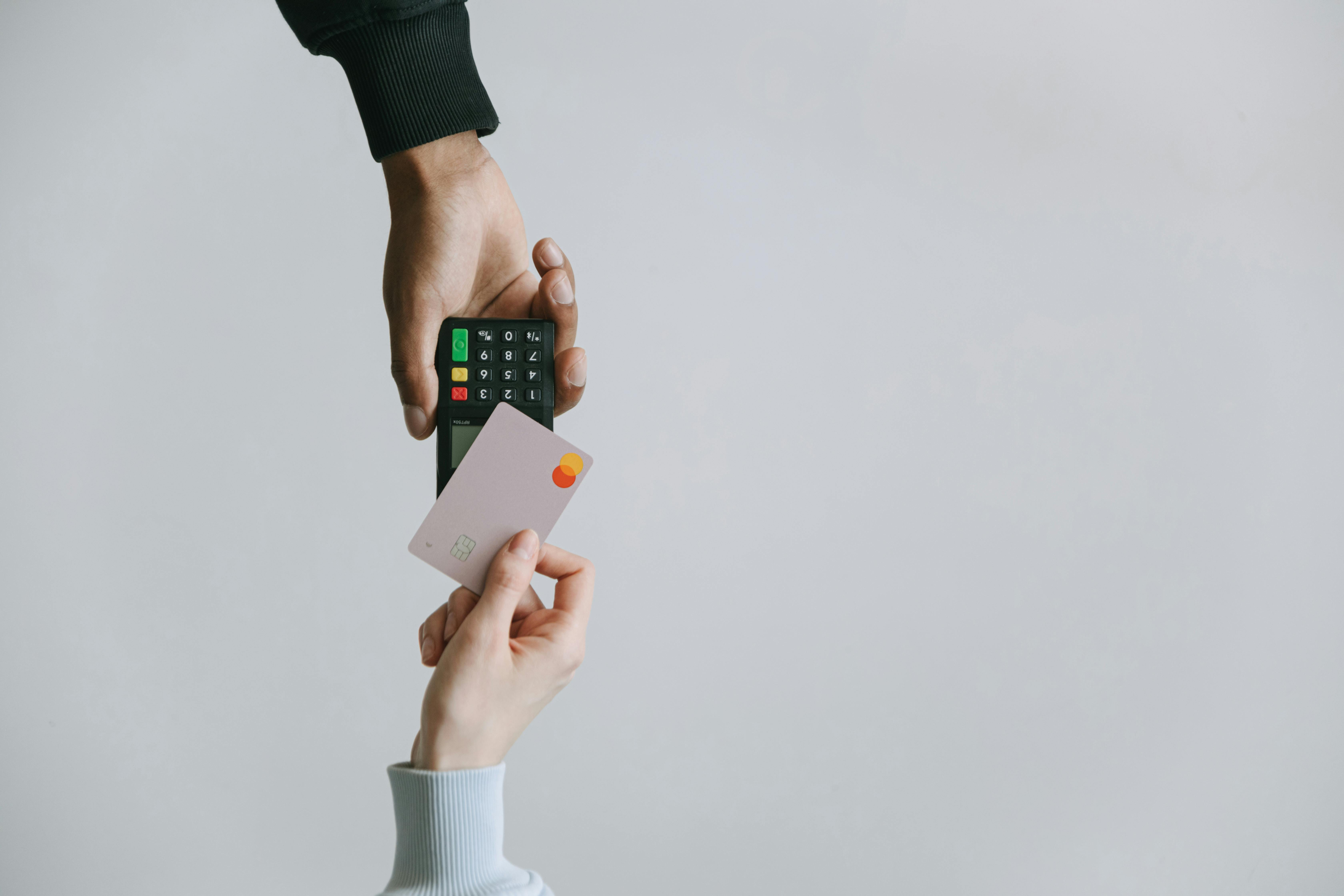 A woman tapping a card on a payment machine | Source: Pexels