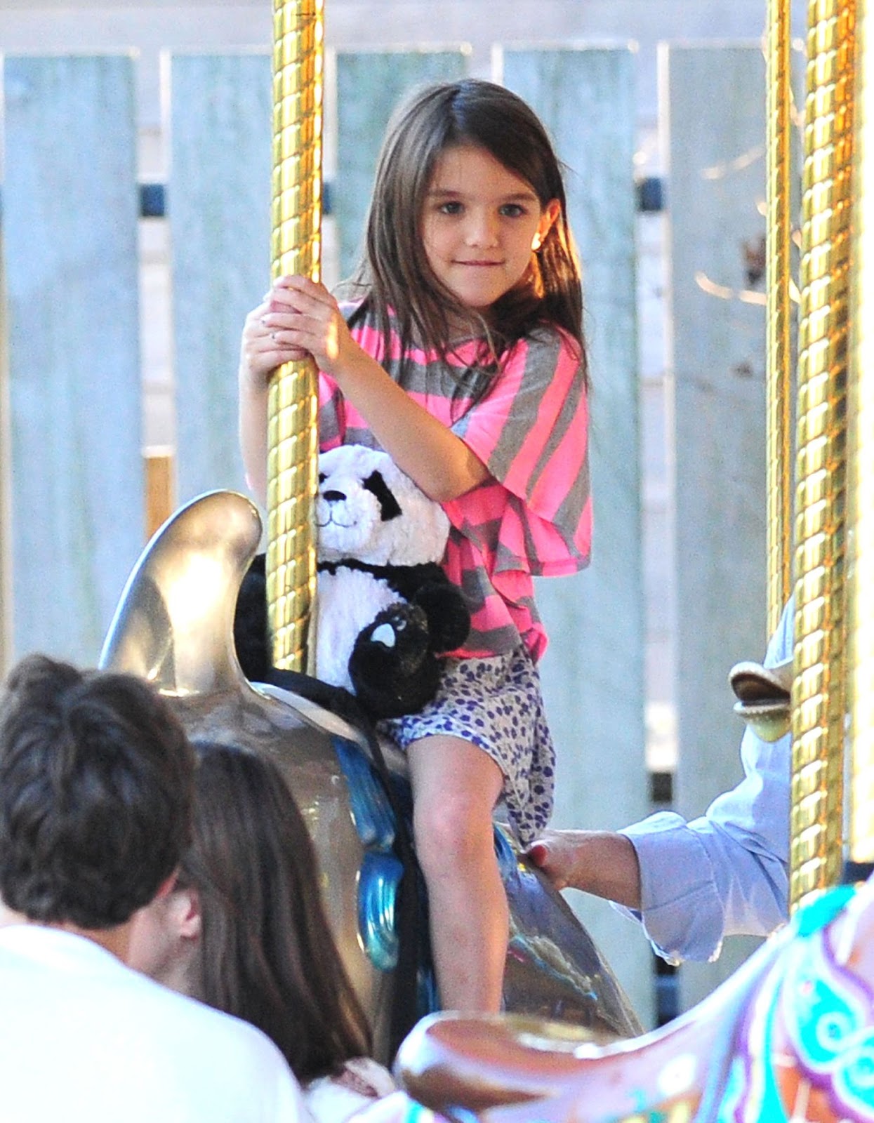 On October 8, 2011, Suri enjoyed a ride on the carousel at Schenley Plaza in Pittsburgh, Pennsylvania, holding a cherished stuffed panda by her side. This moment captured a rare, carefree day with her parents before their separation. | Source: Getty Images