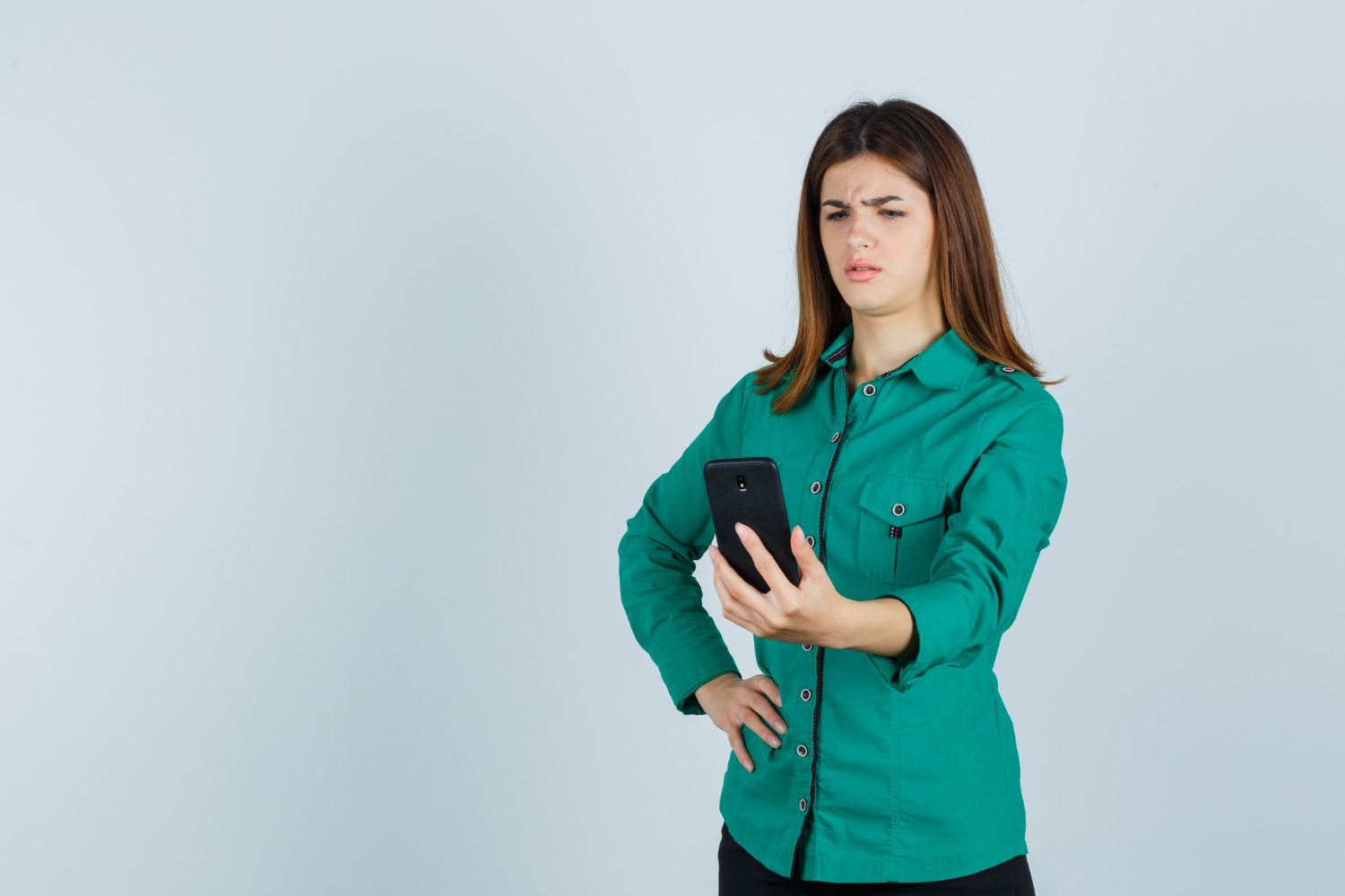 A stunned woman staring at her phone | Source: Freepik