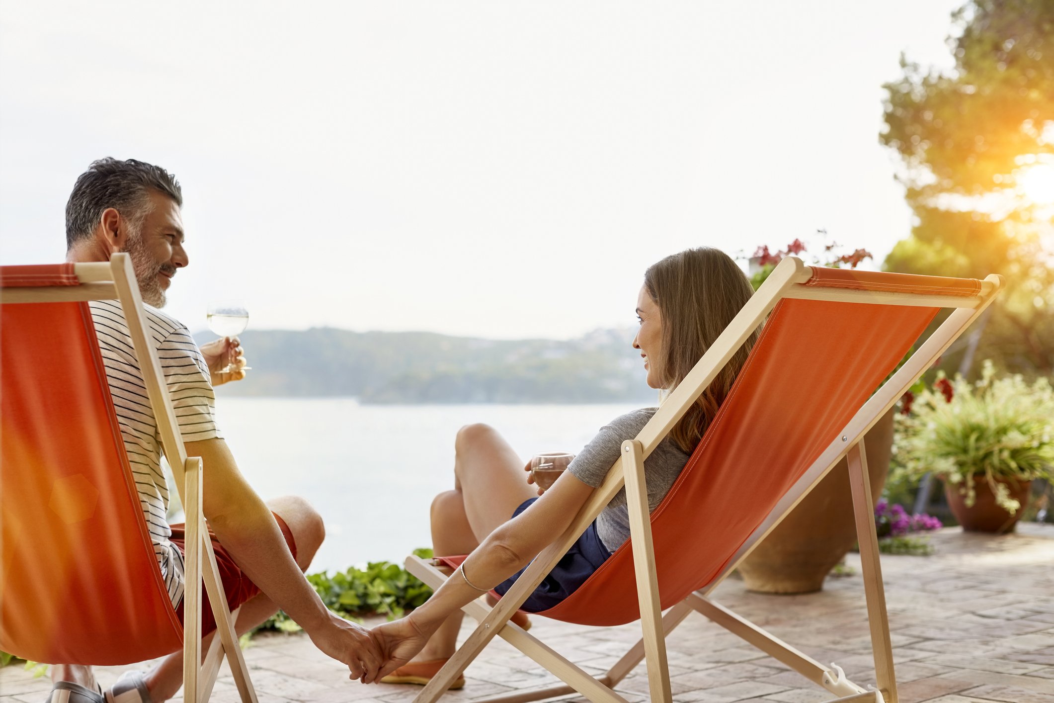 A couple relaxing at the backyard enjoying some wine. | Photo: Getty Images