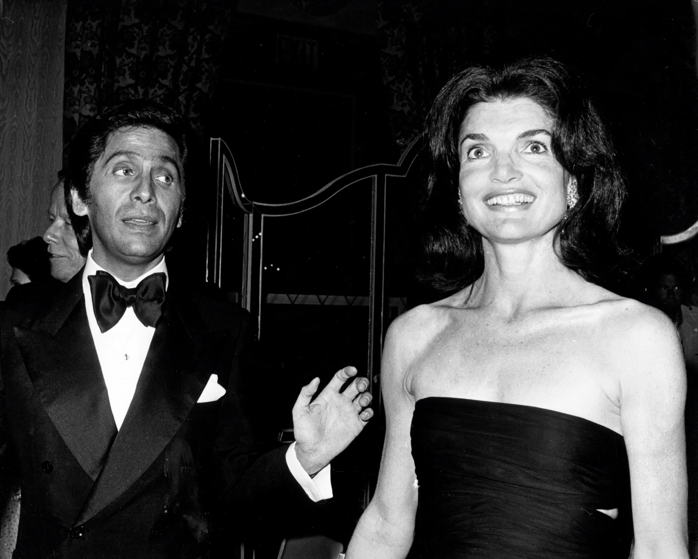 Valentino Garavani with Jacqueline Kennedy Onassis at the Valentino Fashion Show Benefit for the Special Olympics in New York City, on June 7, 1976 | Source: Getty Images