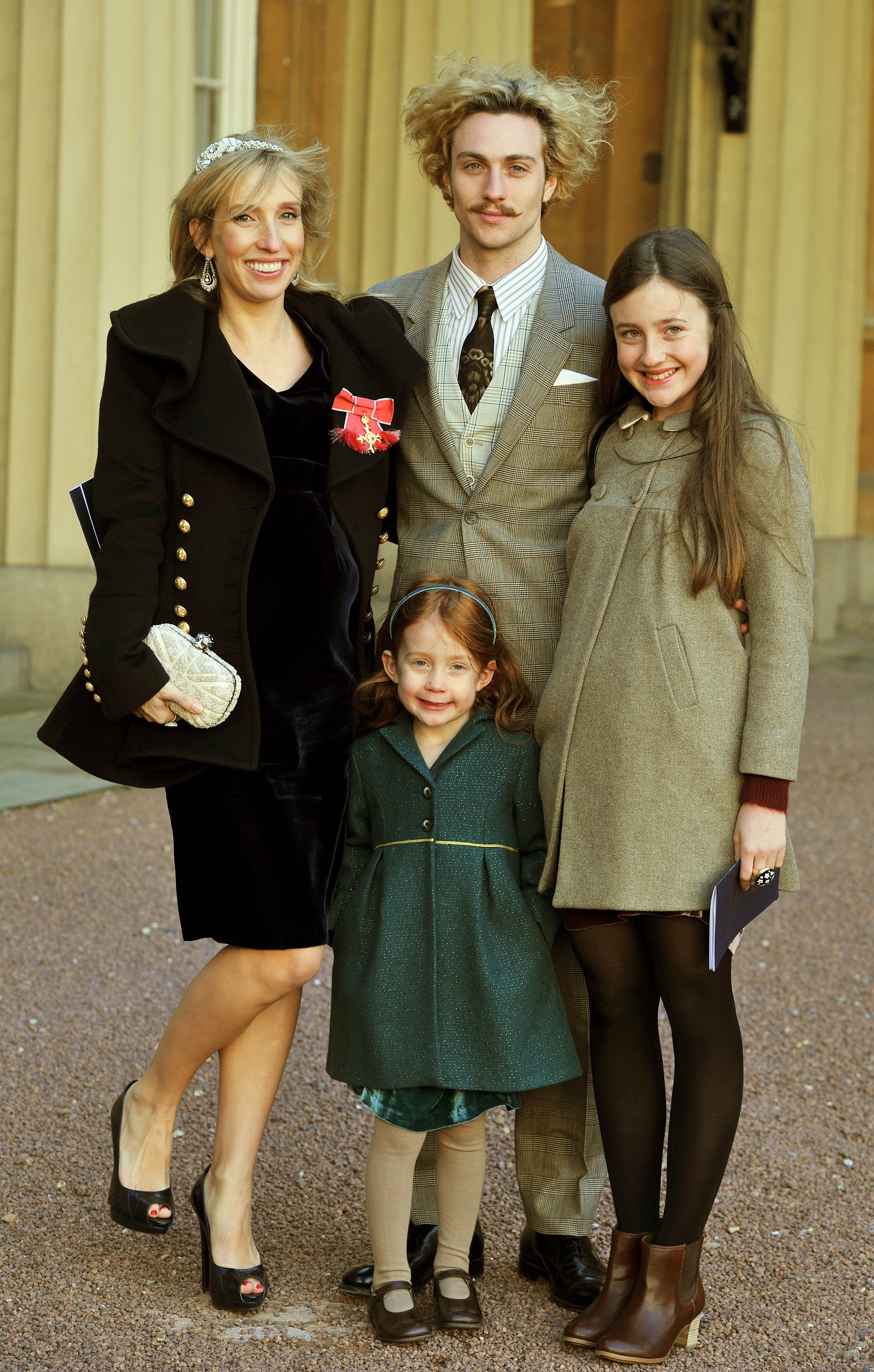 Sam Taylor-Wood and Aaron Johnson and her children Angelica (R) and Jessie during an Investiture Ceremony at Buckingham Palace on December 14, 2011, in London. | Source: Getty Images