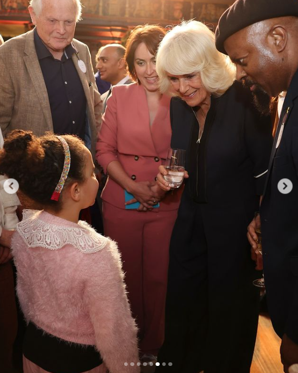 Queen Camilla warmly chats with a little girl at The Queen’s Reading Room Festival 2024. | Source: Instagram
