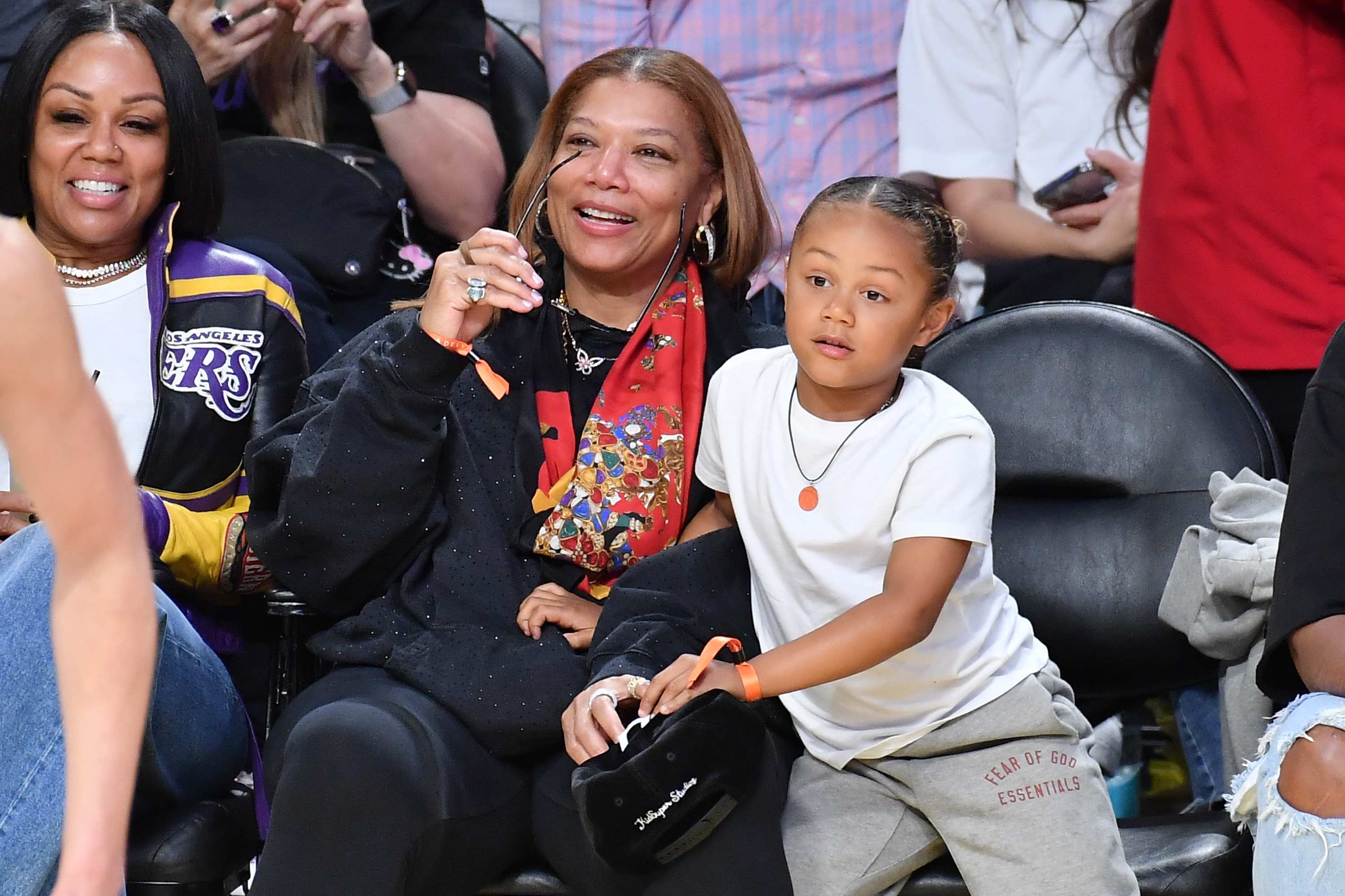 Eboni Nichols and Queen Latifah with Rebel attend a Lakers game in Los Angeles on March 19, 2025 | Source: Getty Images
