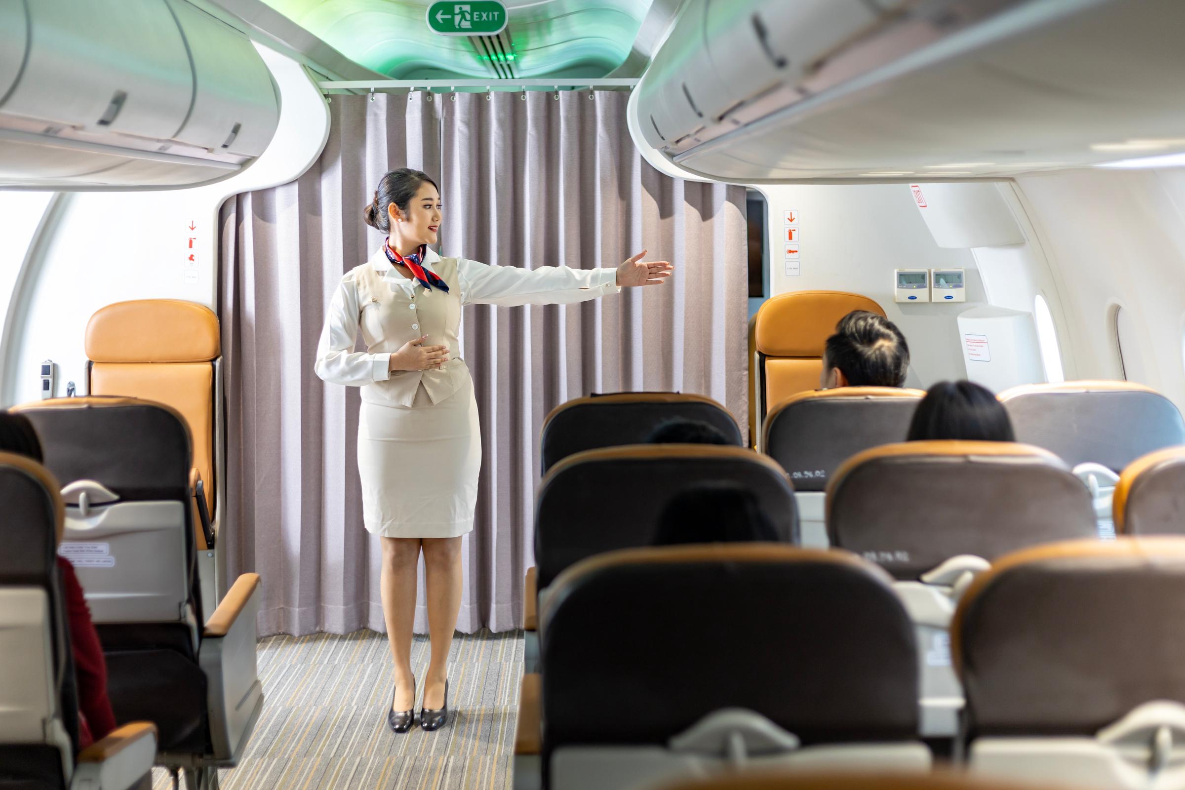 Flight attendant giving instructions | Source: Shutterstock