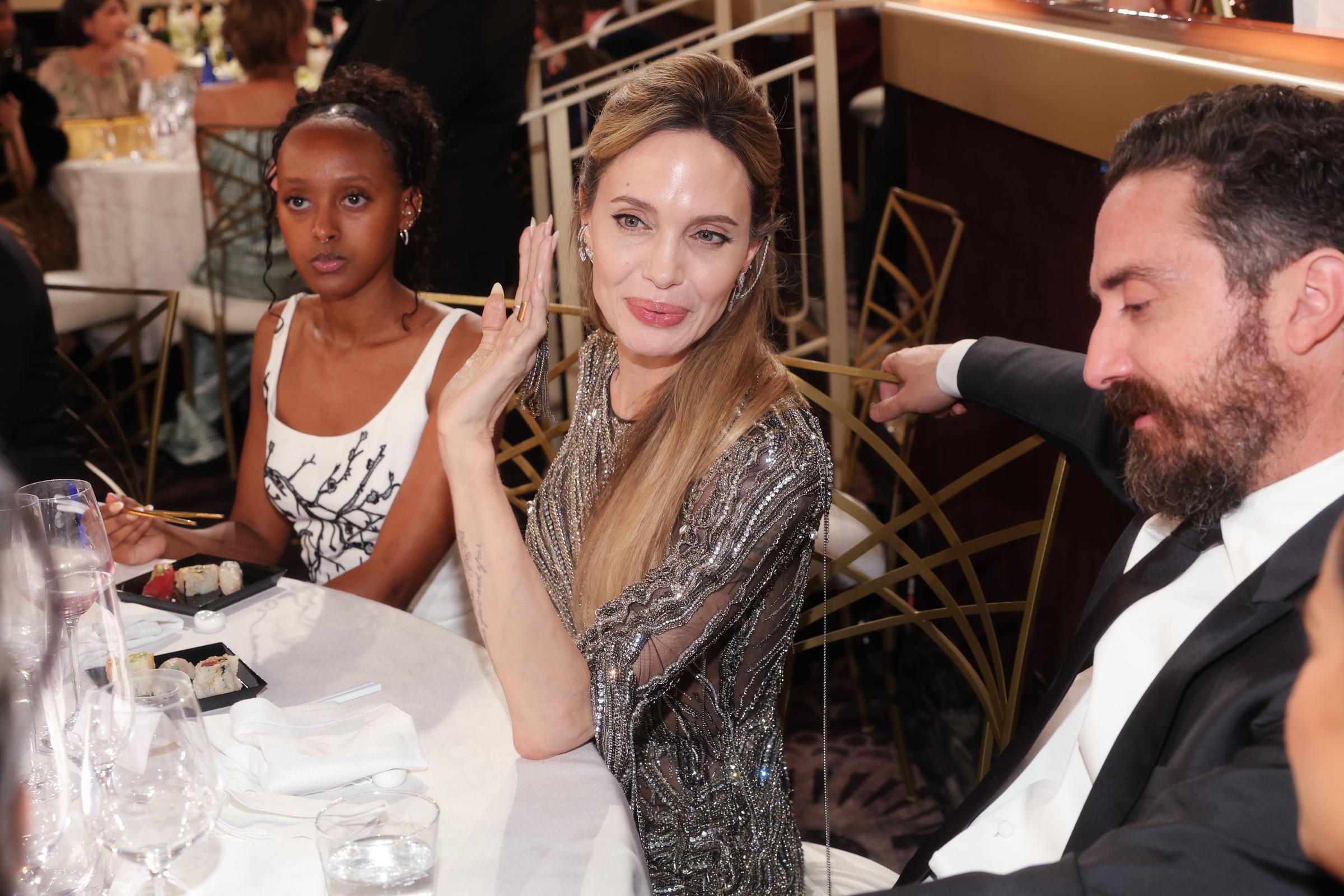 Zahara, her mother Angelina Jolie, and Pablo Larrain at at the 82nd annual Golden Globe Awards at the Beverly Hilton in Beverly Hills, California, on January 5, 2025 | Source: Getty Images