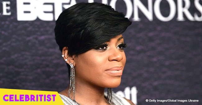 Fantasia's daughter stuns in black dress and orange coat in recent video