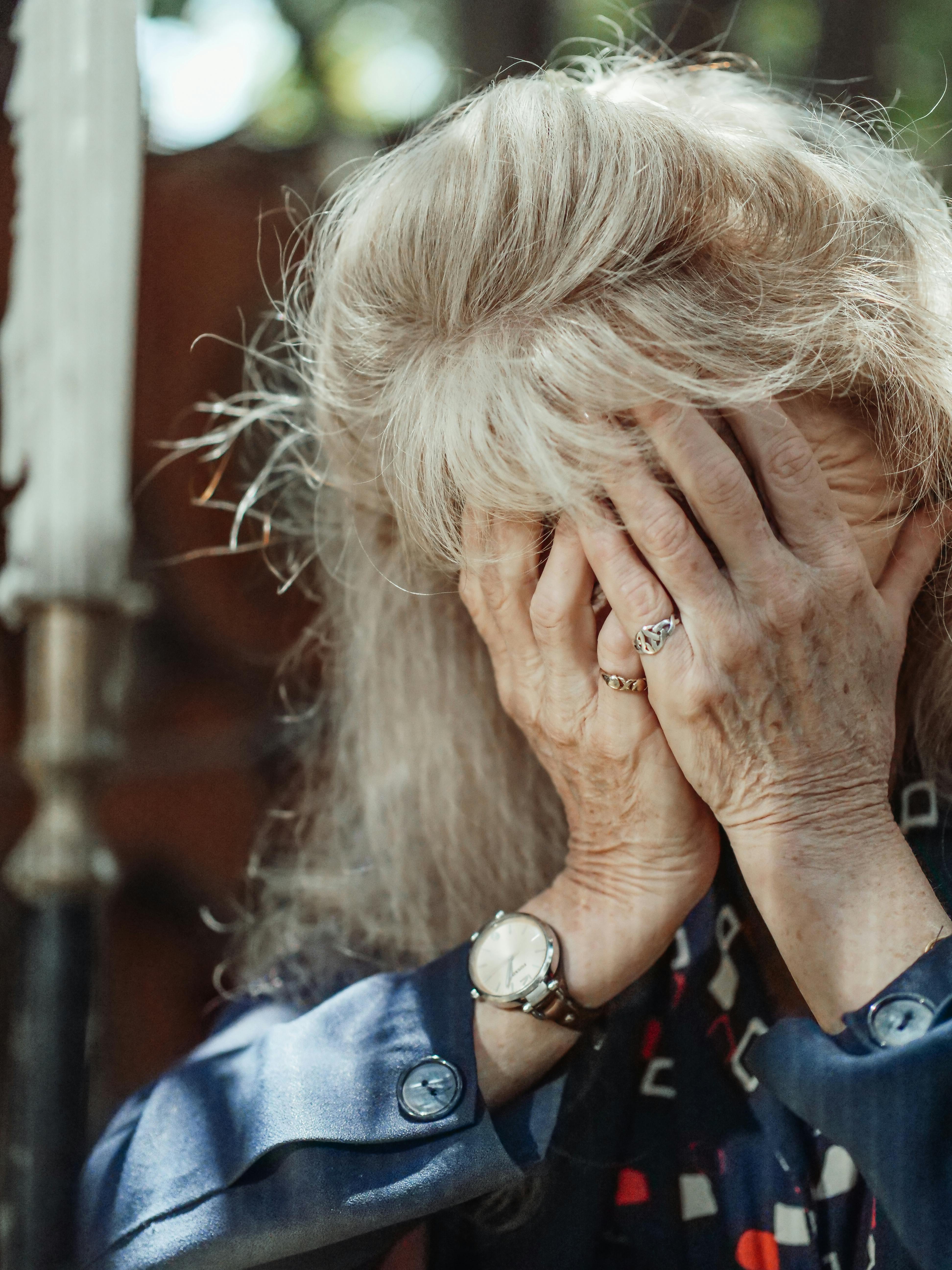 A woman covering her face with her hands | Source: Pexels