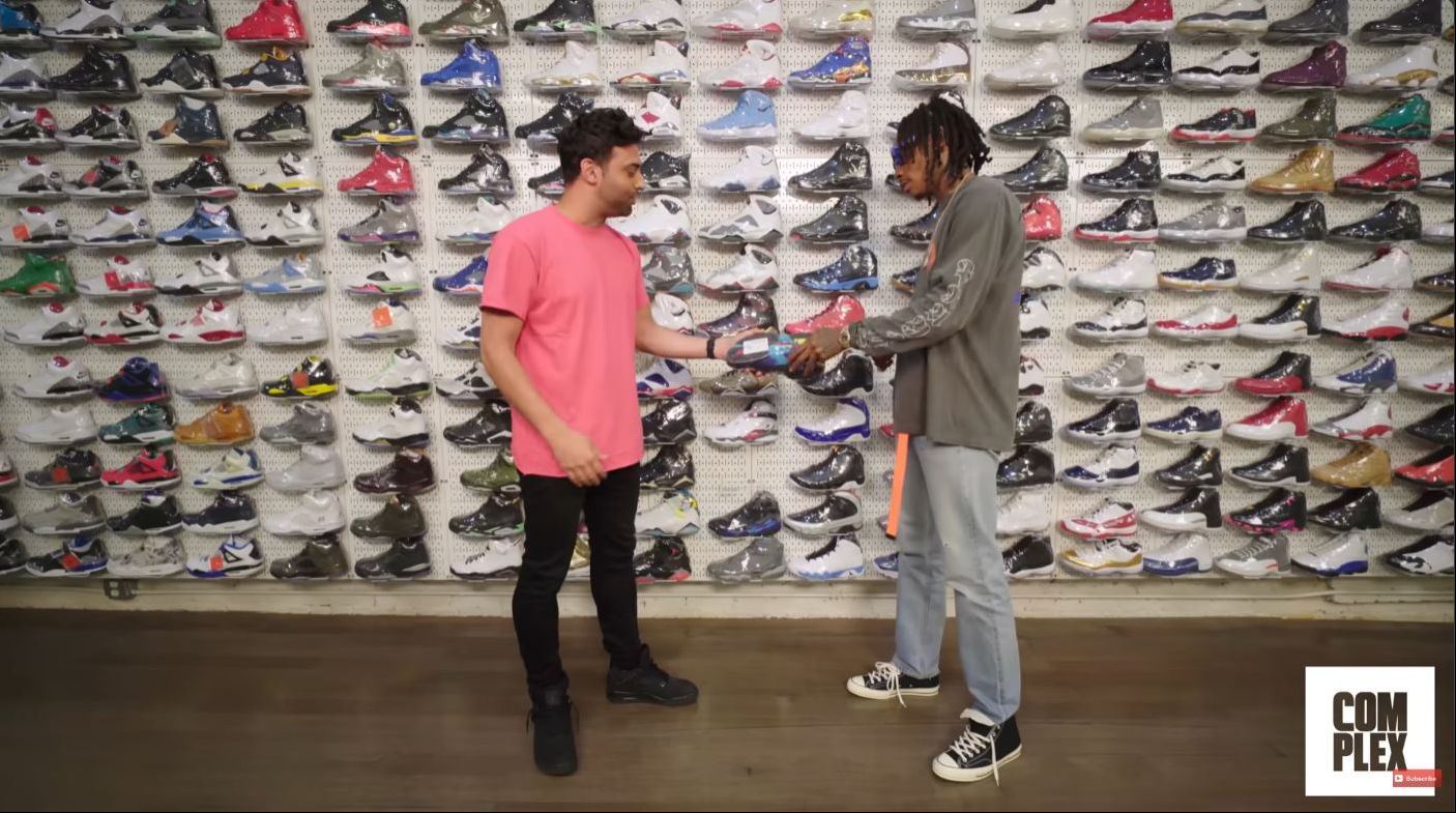 Wiz Khalifa examined a pair of Air Jordan VIII "Aqua" sneakers while recalling the 2012 Complex cover shoot where he famously wore the iconic colorway. | Source: YouTube/Complex