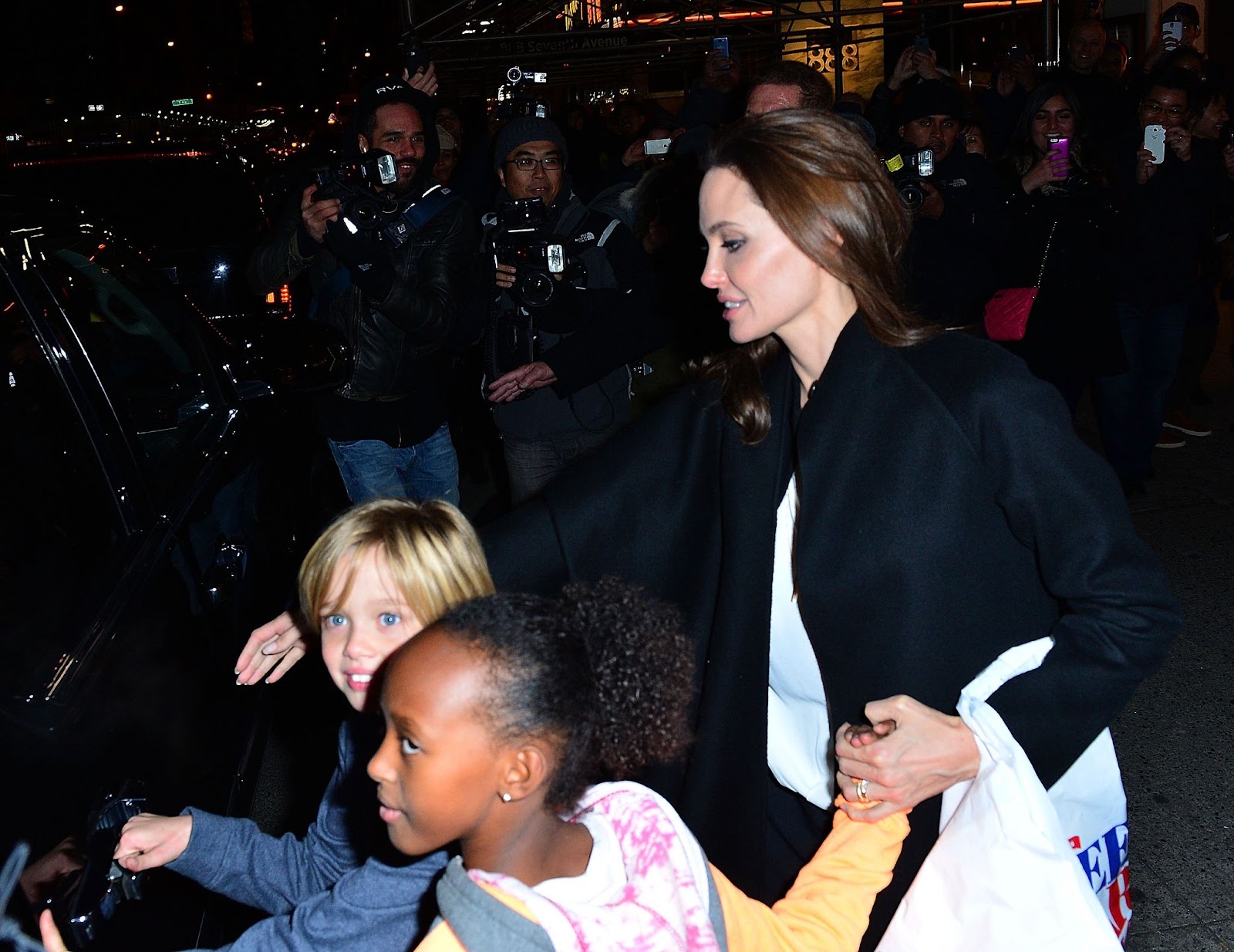 Angelina Jolie with Zahara and Shiloh at Lee's Art Shop in New York on November 21, 2014. | Source: Getty Images