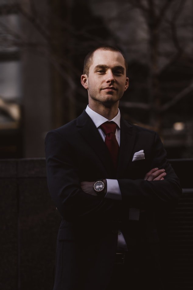 A man looking pleased in a suit | Photo: Unsplash