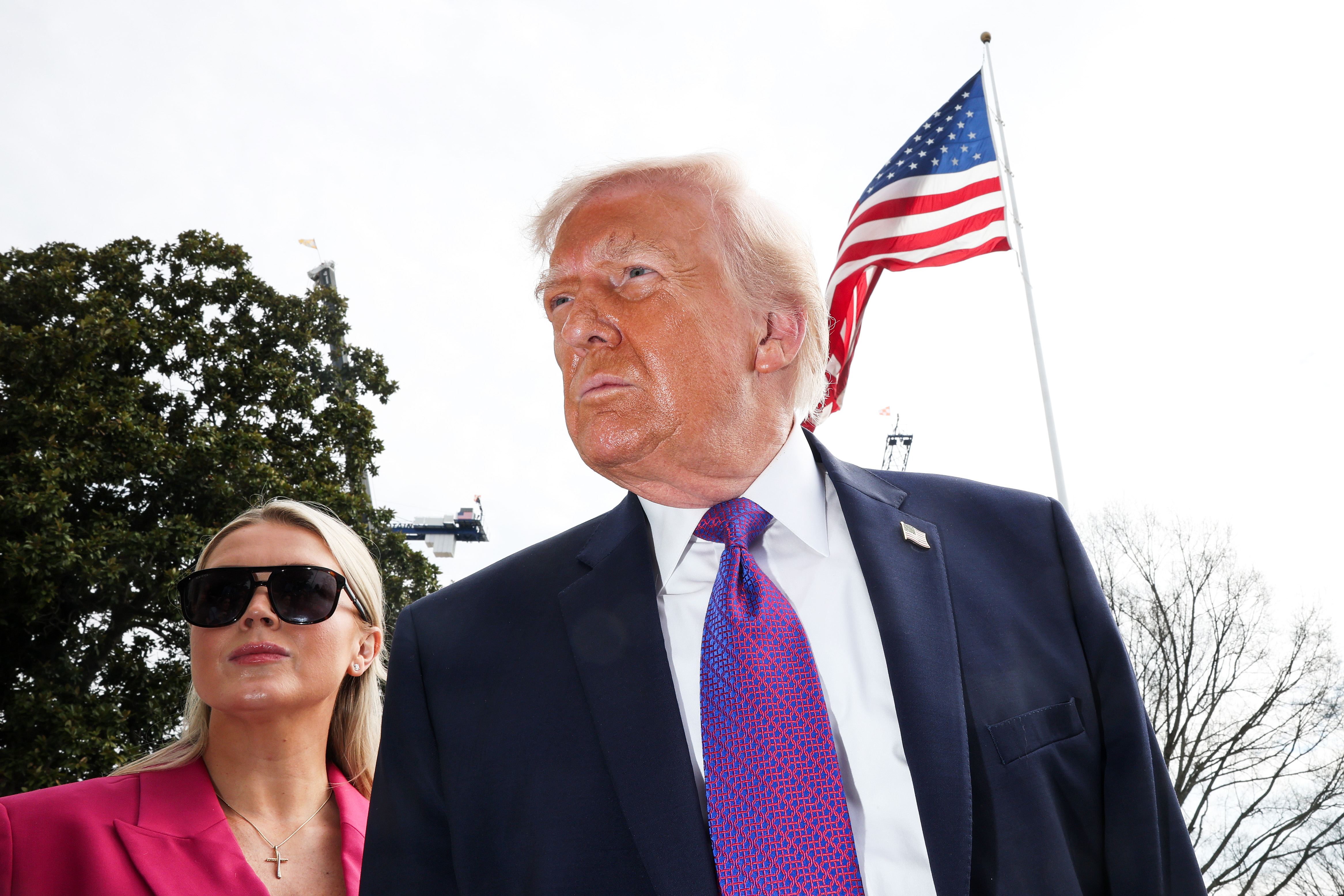 Donald Trump speaks to reporters alongside Karoline Leavitt as he departs for Marine One on the South Lawn of the White House on March 11, 2026 in Washington, DC | Source: Getty Images