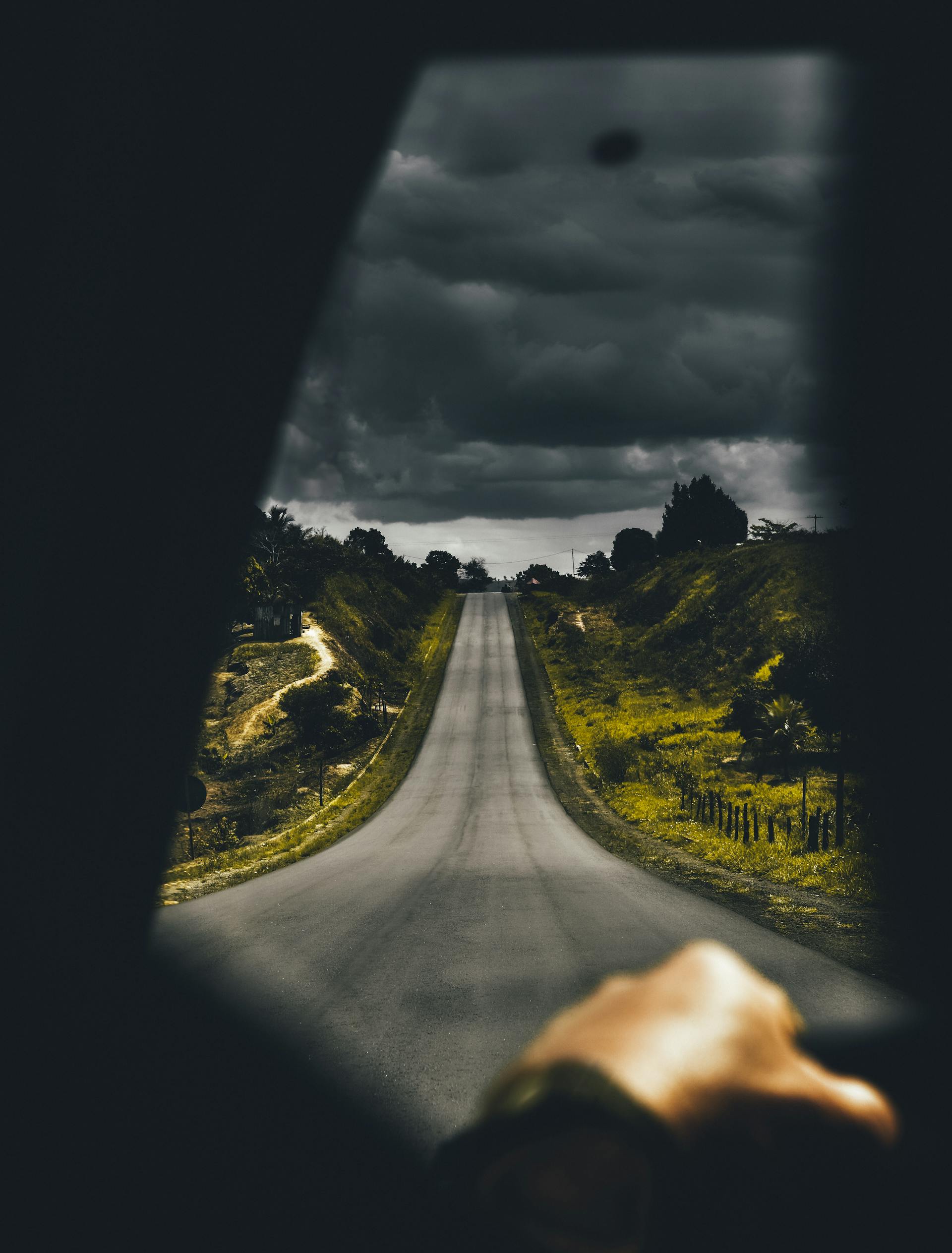 A person driving down a lonely road | Source: Pexels