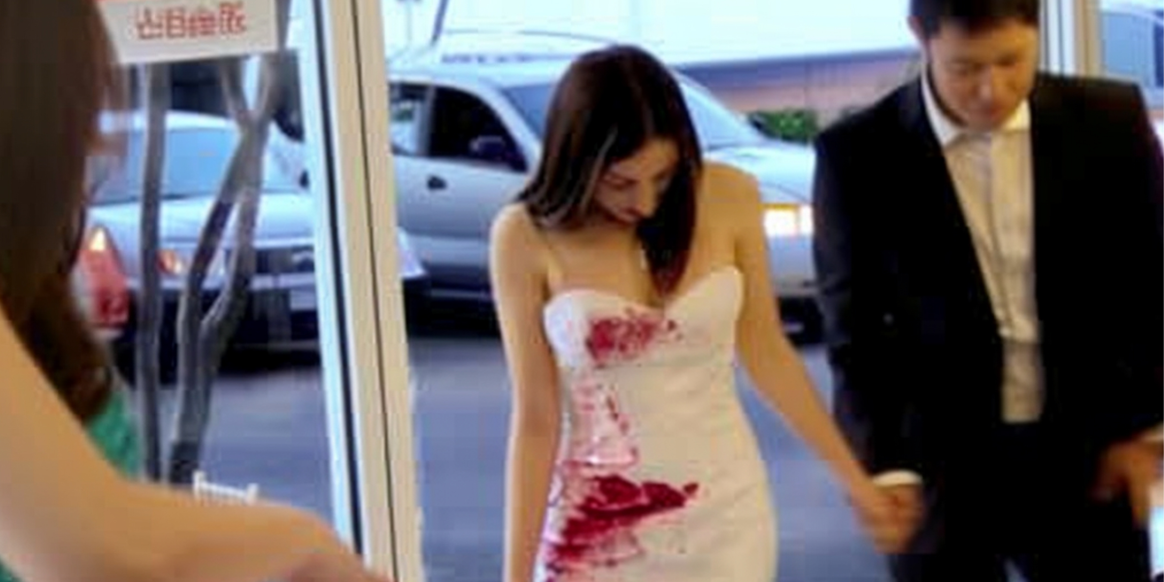 A sad bride with red paint on her dress accompanied by the groom | Source: Amomama