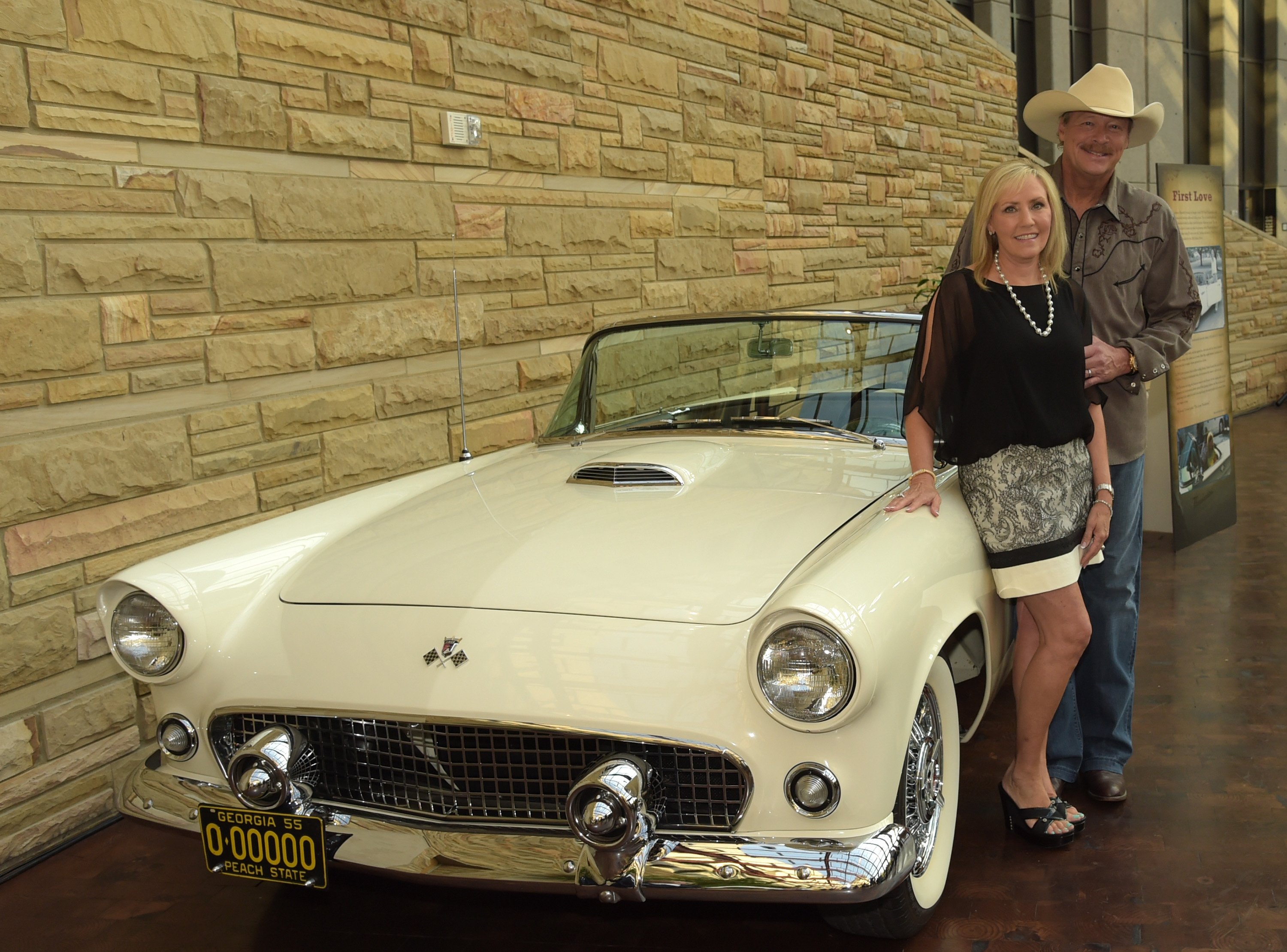 enise and Alan Jackson pose beside Jackson's 1955 Ford Thunderbird at the opening of his "Alan Jackson: 25 Years of Keepin' It Country" exhibit at the Country Music Hall of Fame and Museum on August 27, 2014 in Nashville, Tennessee | Source: Getty Images 