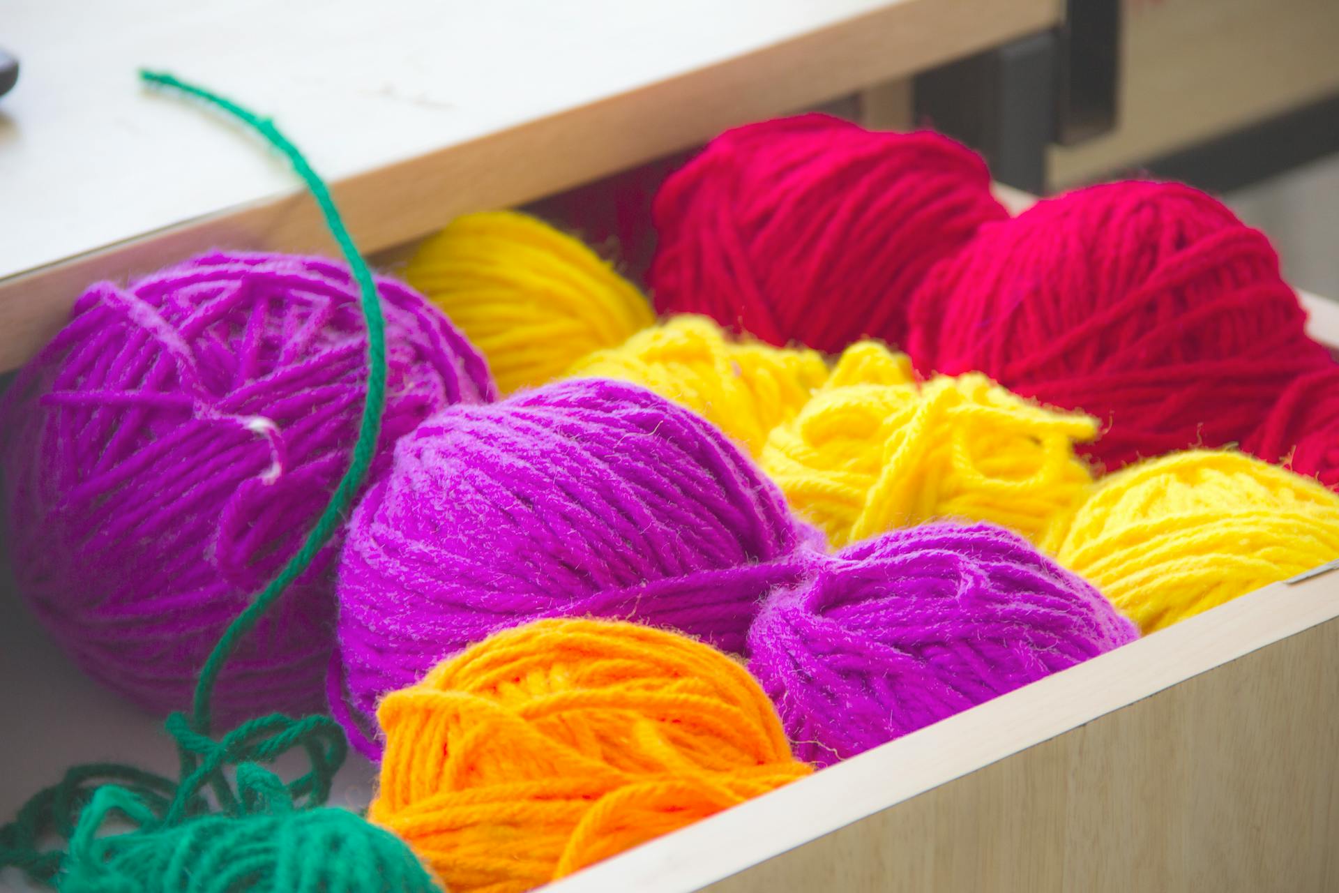 Colorful balls of yarn in a drawer | Source: Pexels