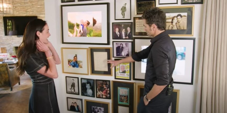 John Stamos showing of the frames on the wall of his Beverly Hills home. | Source: YouTube/Architectural Digest
