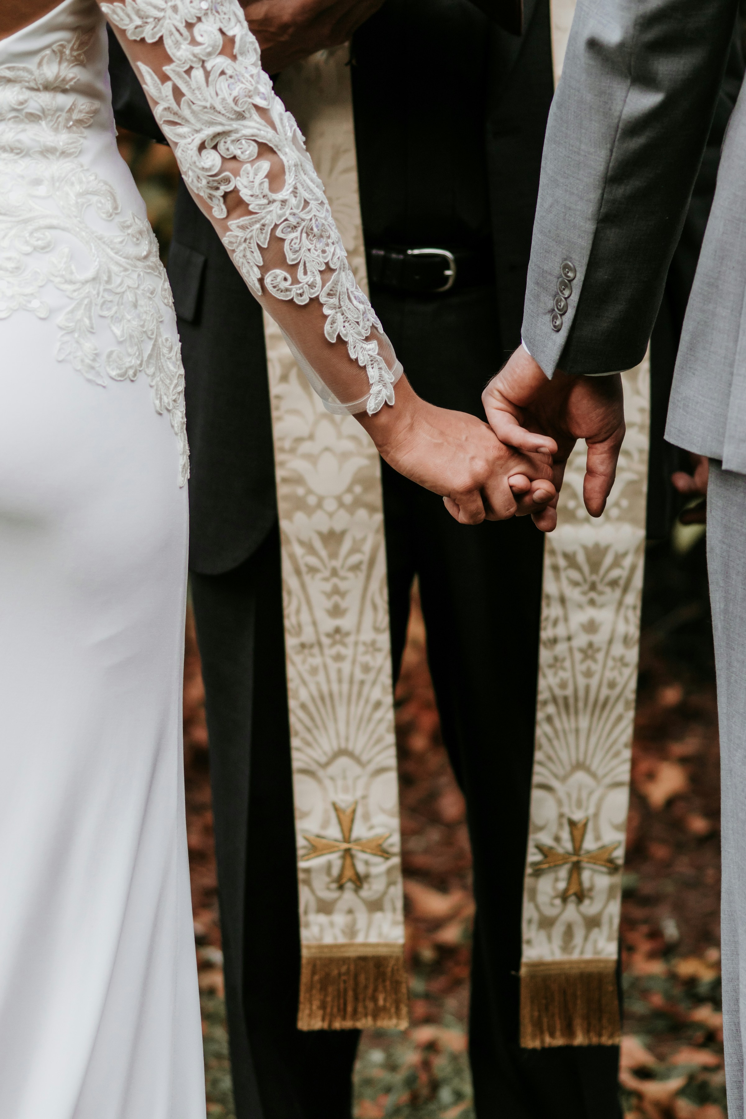 A couple standing in front of a priest | Source: Unsplash