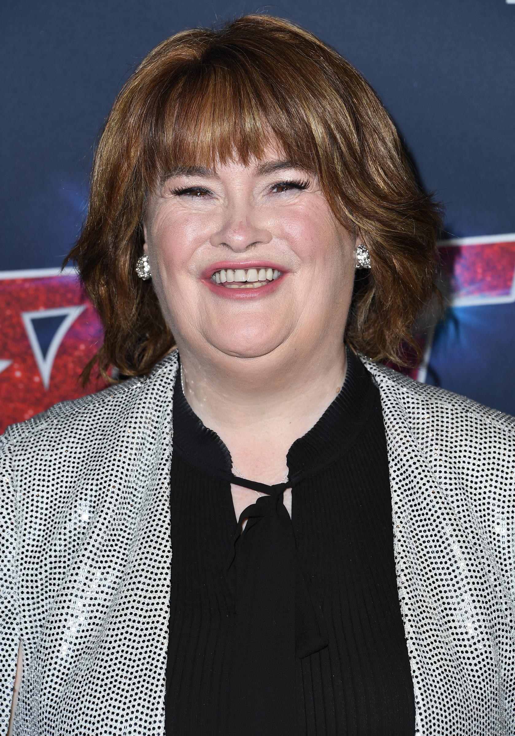 A radiant Boyle flashes a wide smile on the red carpet at the Dolby Theatre in Hollywood on 20 August 2019, wearing a silver sequinned jacket over a black top at the "America's Got Talent" Season 14 live show.