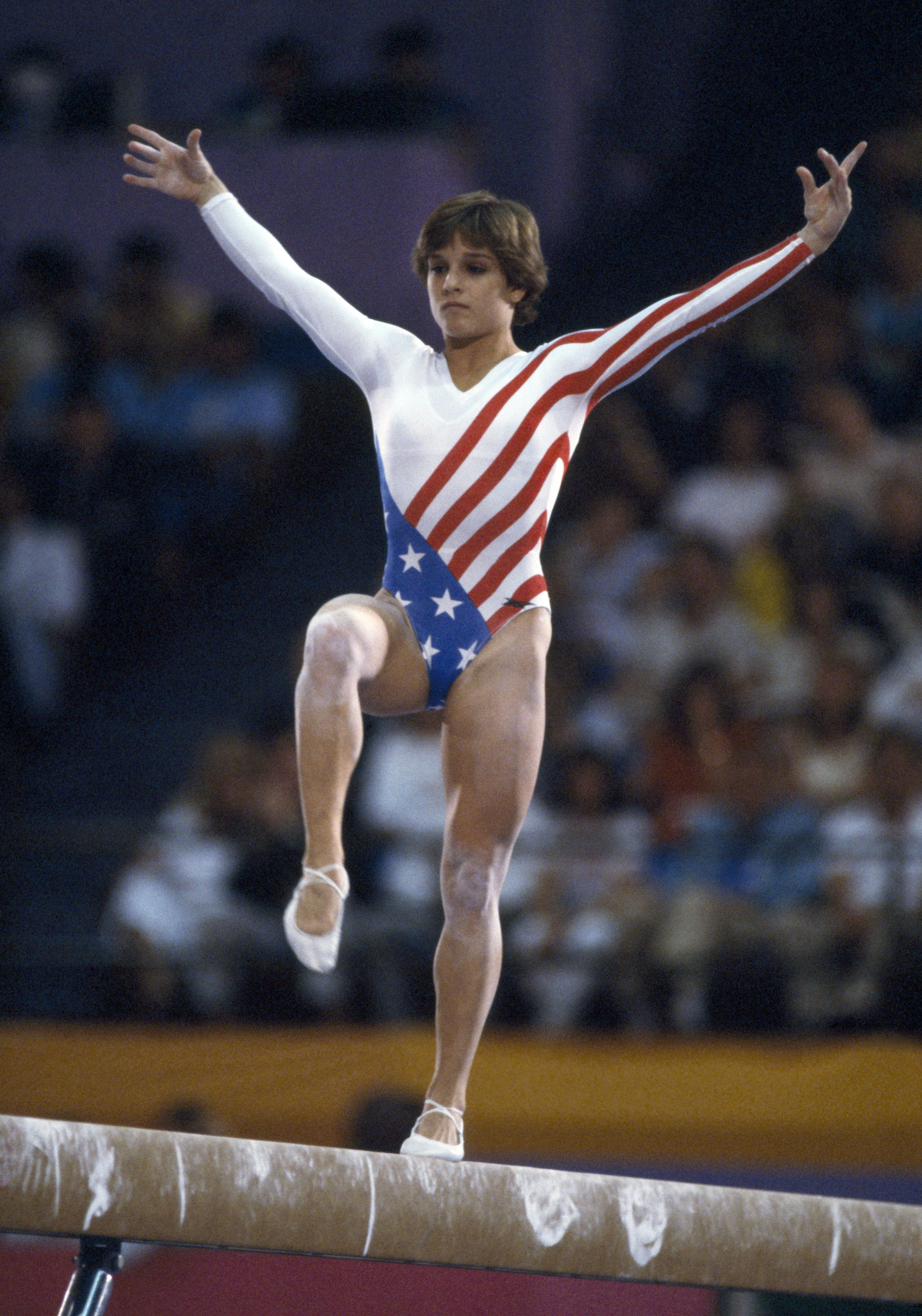 Mary Lou Retton competes on the balance beam during competition in the Women's artistic individual all-around event at the 1984 Summer Olympics, inside the Pauley Pavilion, in Los Angeles, in July 1984.