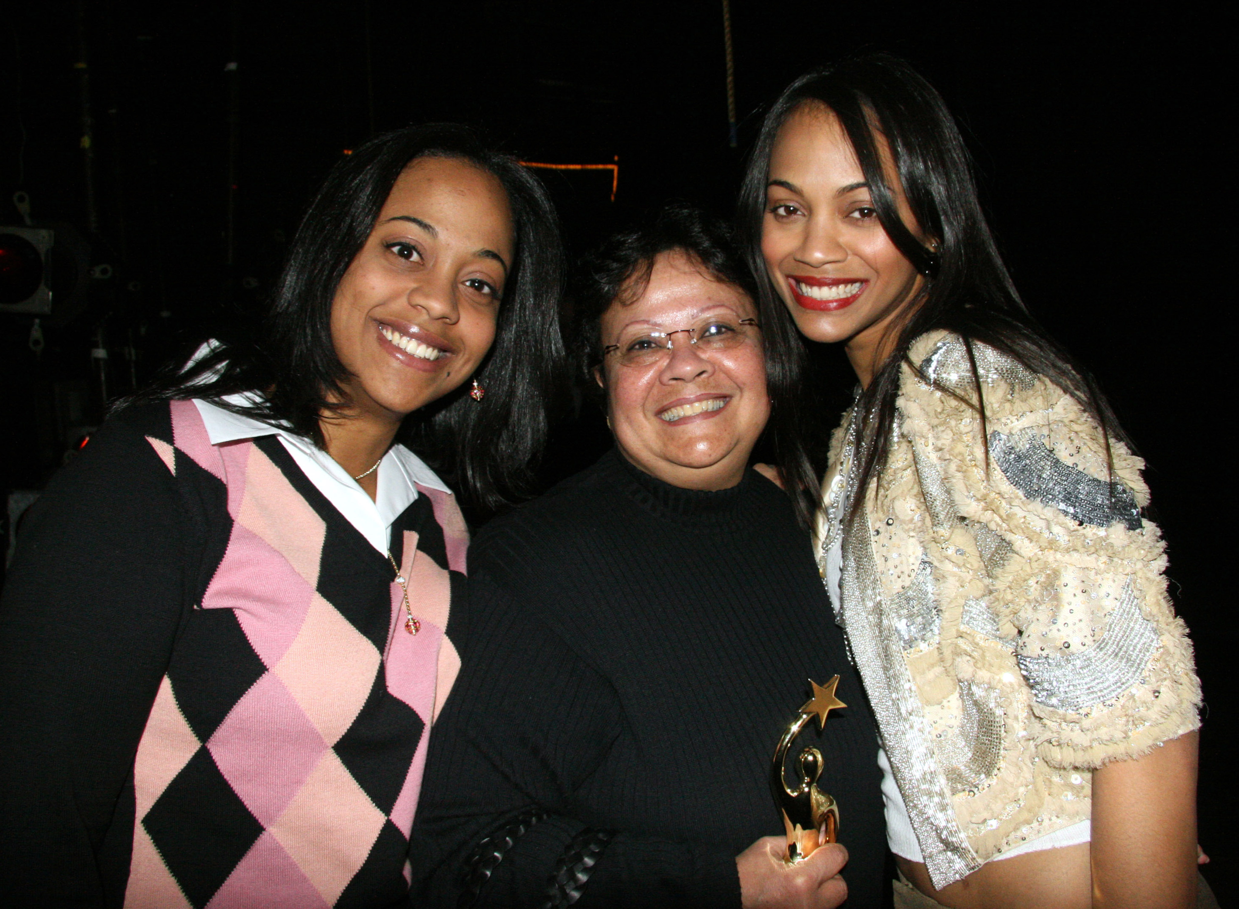 Zoe Saldana with her mother [C] and sister [L] during Television Dominicana Presents La Maldicion Del Padre Cardona on April 5, 2006, at Lehman College Center in New York | Source: Getty Images