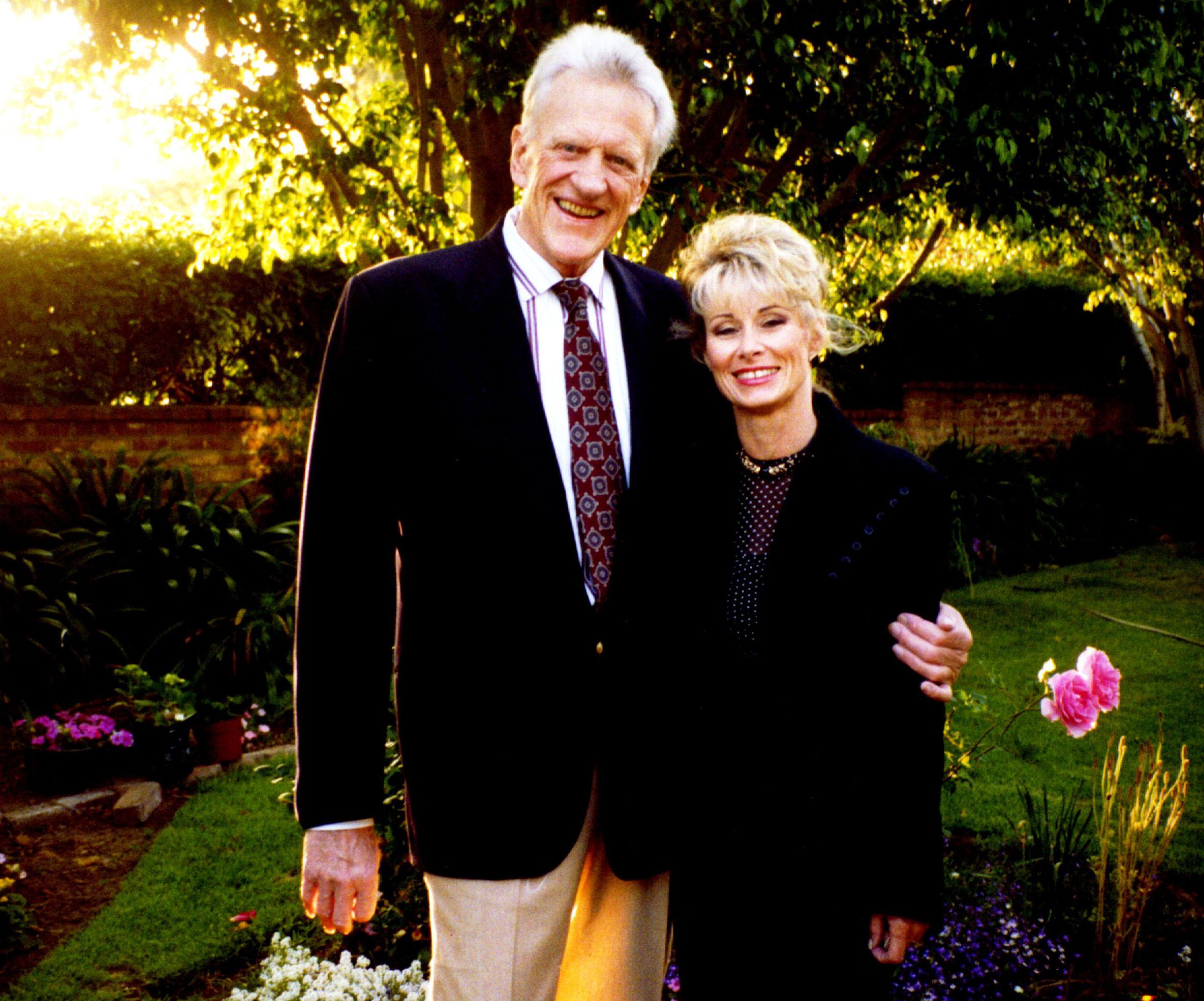 James "Jim" Arness And Wife Janet Pose For A Photograph In Their Garden In 1995 In Brentwood, Ca. Arness Became Famous In Hollywood In 1955 | Source: Getty Images