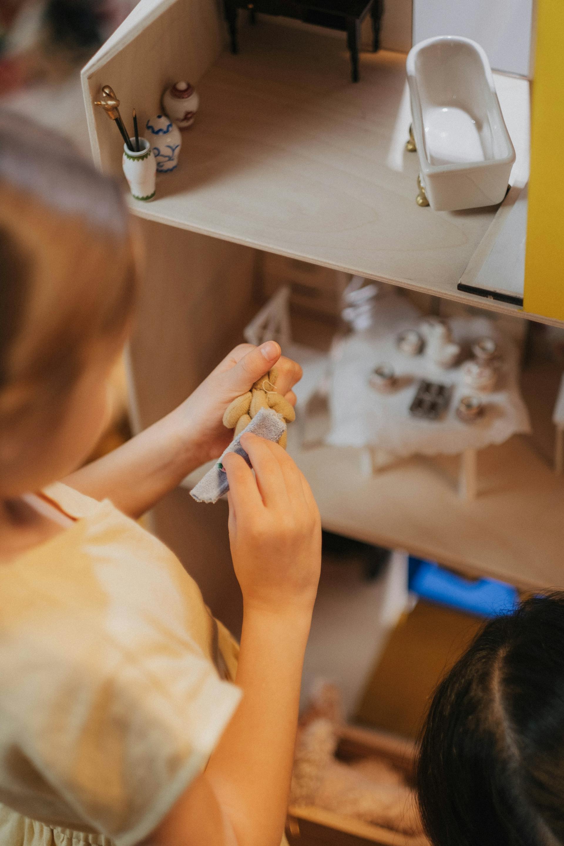 A child playing with a dollhouse | Source: Pexels