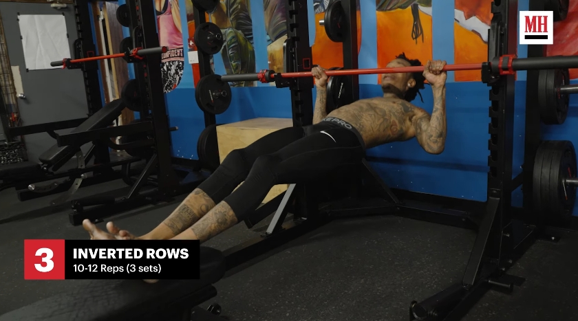 Wiz Khalifa performs an inverted row exercise during the strength-training portion of his MMA-style workout routine. | Source: YouTube/Men's Health