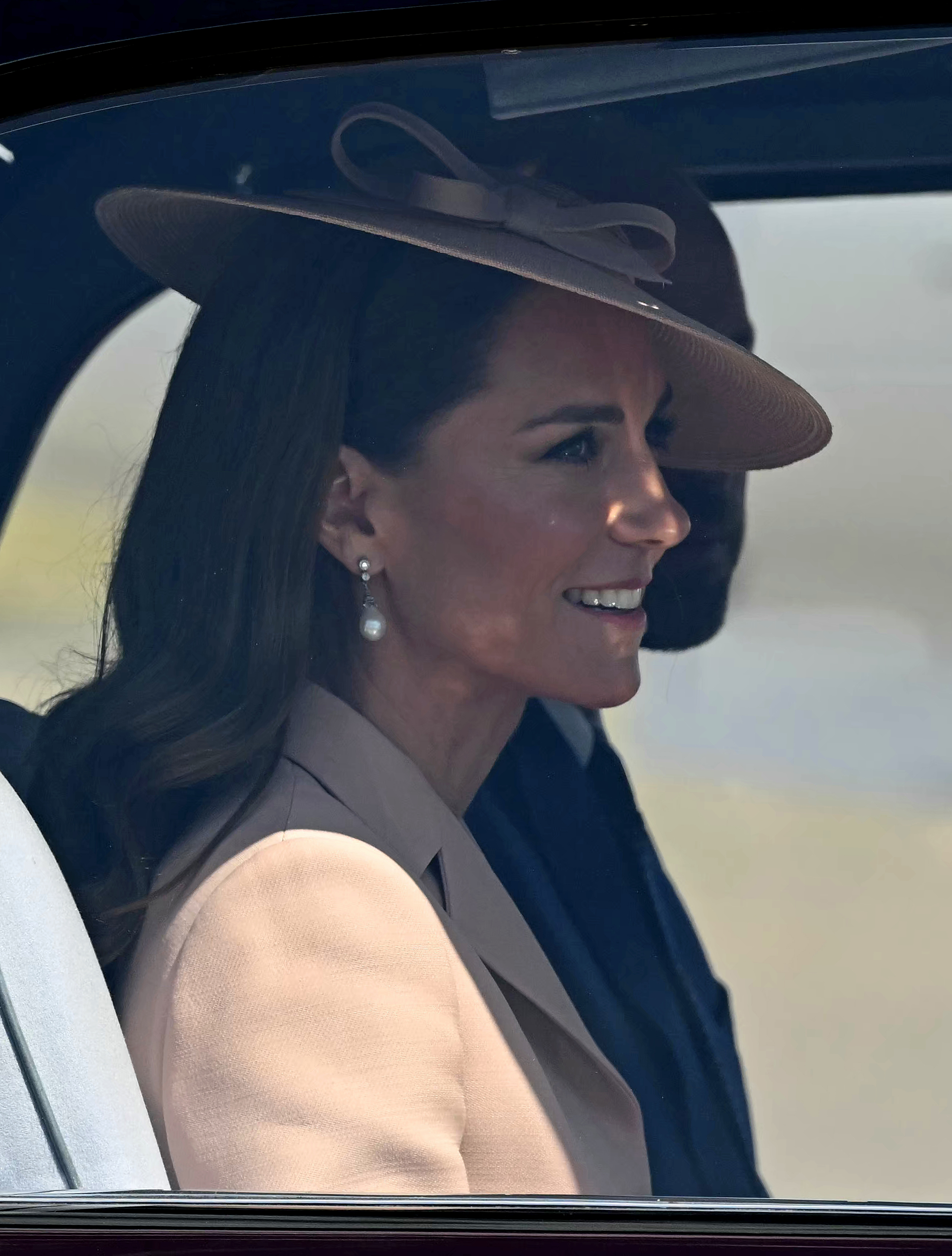 A closer look at Princess Catherine's pearl drop earrings and designer hat as she and Prince William departed RAF Northolt en route to Windsor Castle.