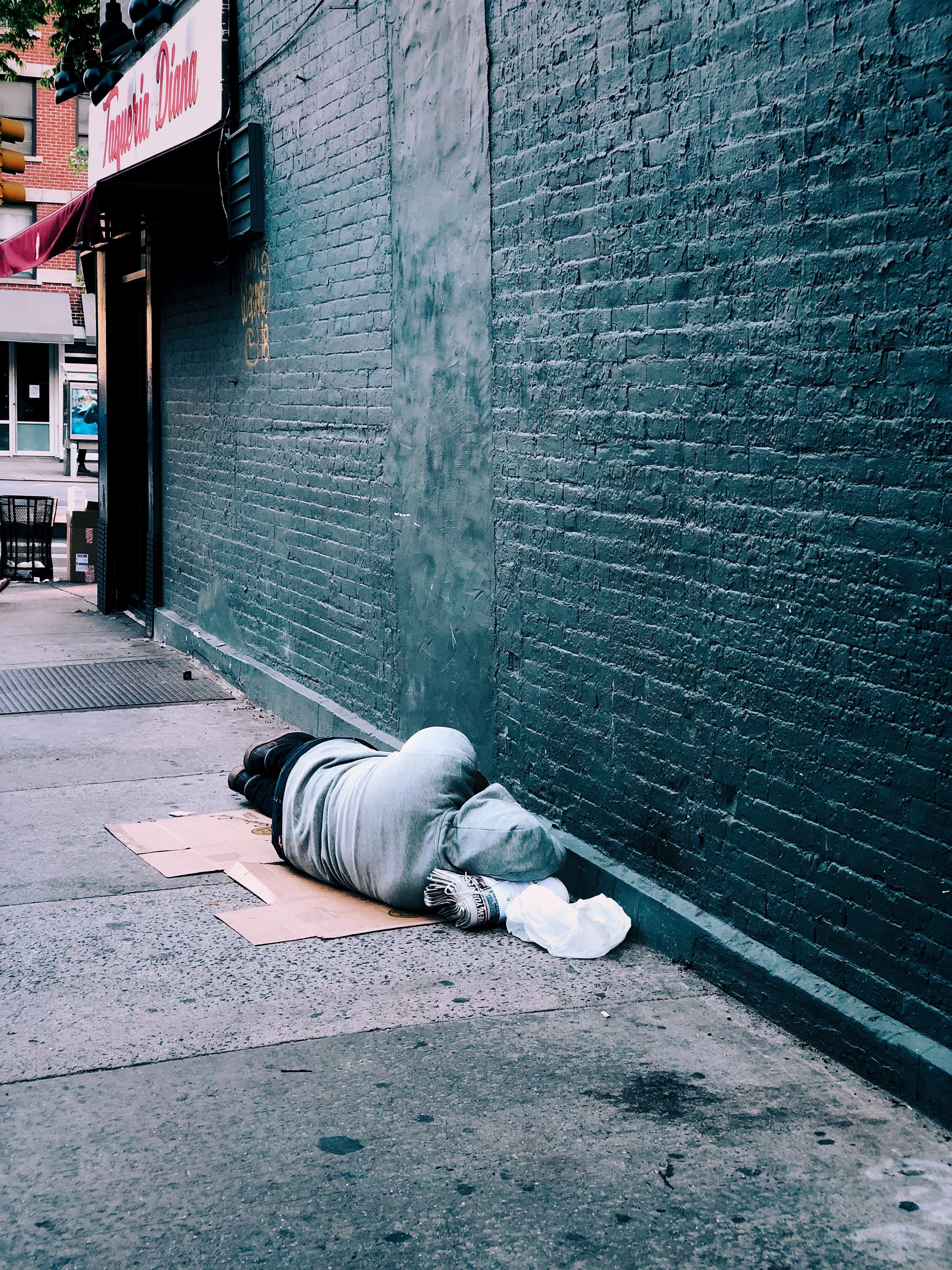 Man lying on brown cardboard | Source: Unsplash