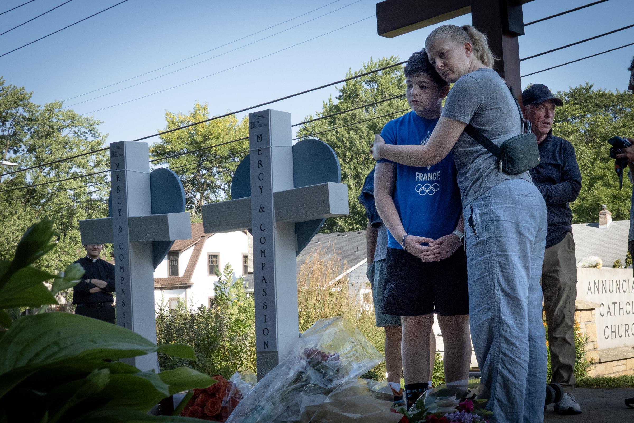 People visiting a memorial in front of Annunciation Catholic Church on August 28, 2025, in Minneapolis, Minnesota. | Source: Getty Images