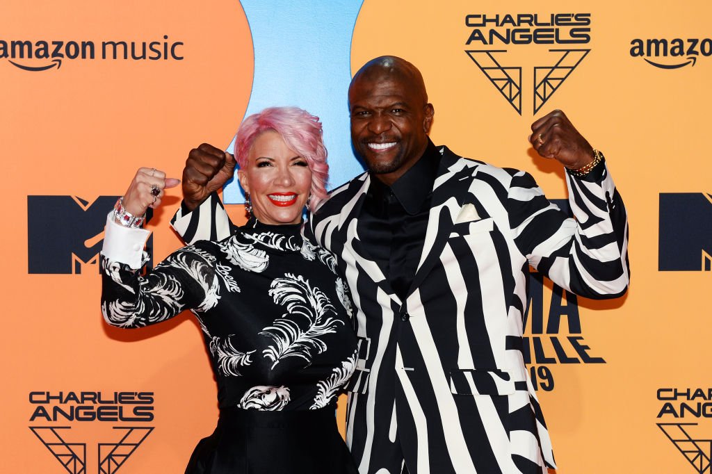 Rebecca Crews and Terry Crews pose with the arms in the air as the arrived at the MTV EMA Awards on November 03, 2019, in Seville, Spain | Source: Kate Green/Getty Images for MTV
