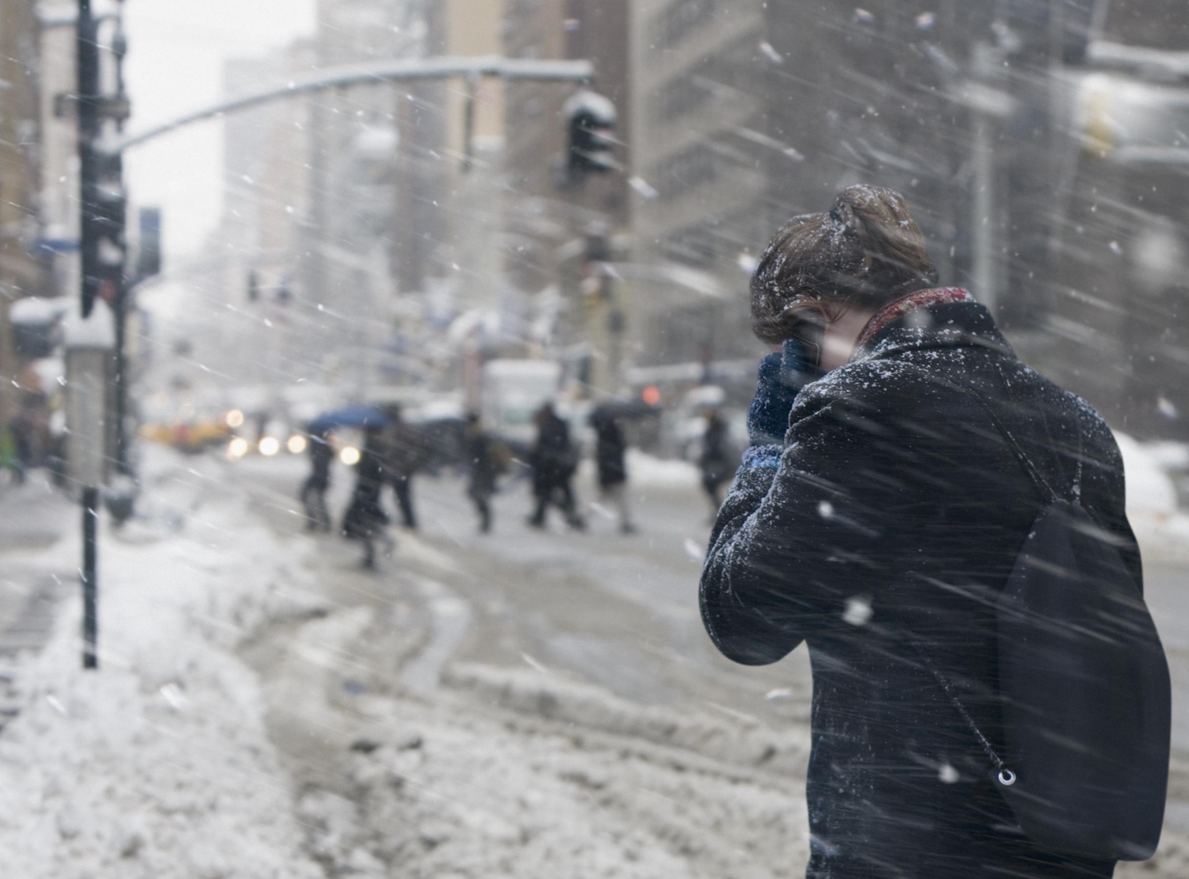 A woman communicating on cell phone in the snow, dated February 13, 2012 | Source: Getty Images