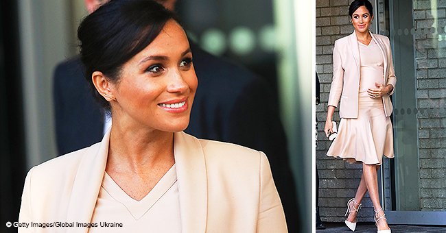 Meghan Markle wows in blush pink dress at the National Theatre, showing off her growing baby bump