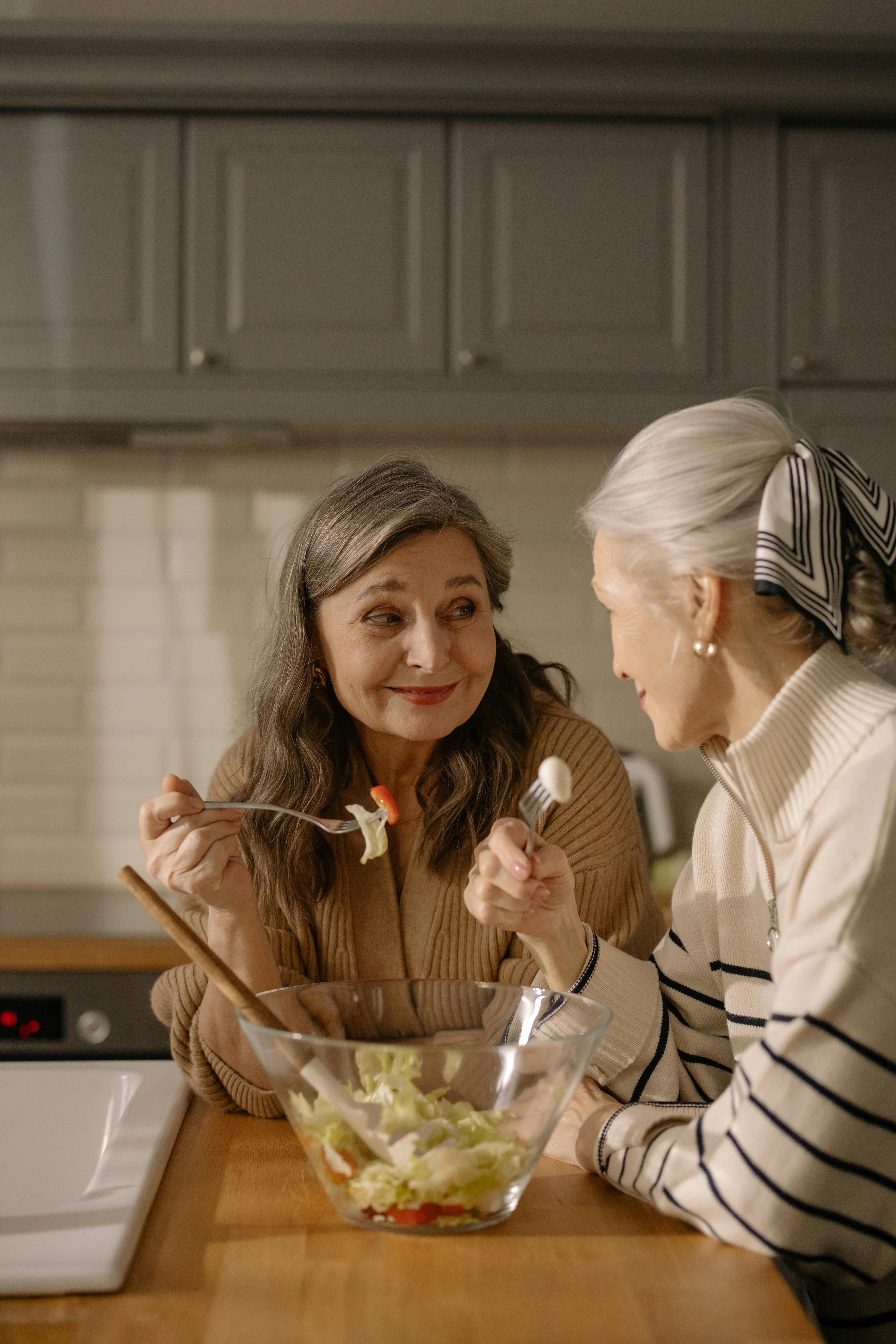 A woman eating with a friend | Source: Getty Images