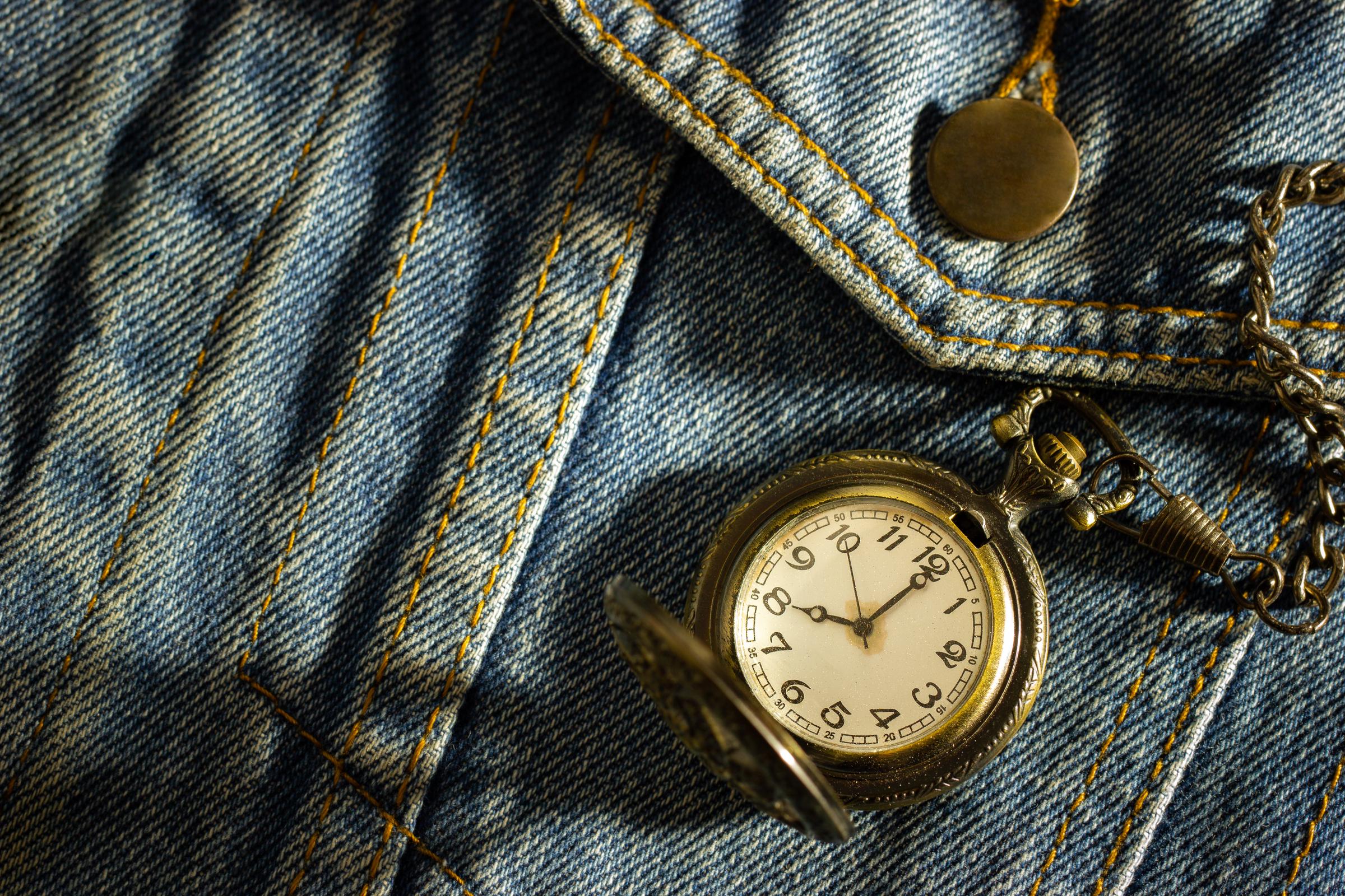 Vintage pocket watch over denim | Source: Shutterstock