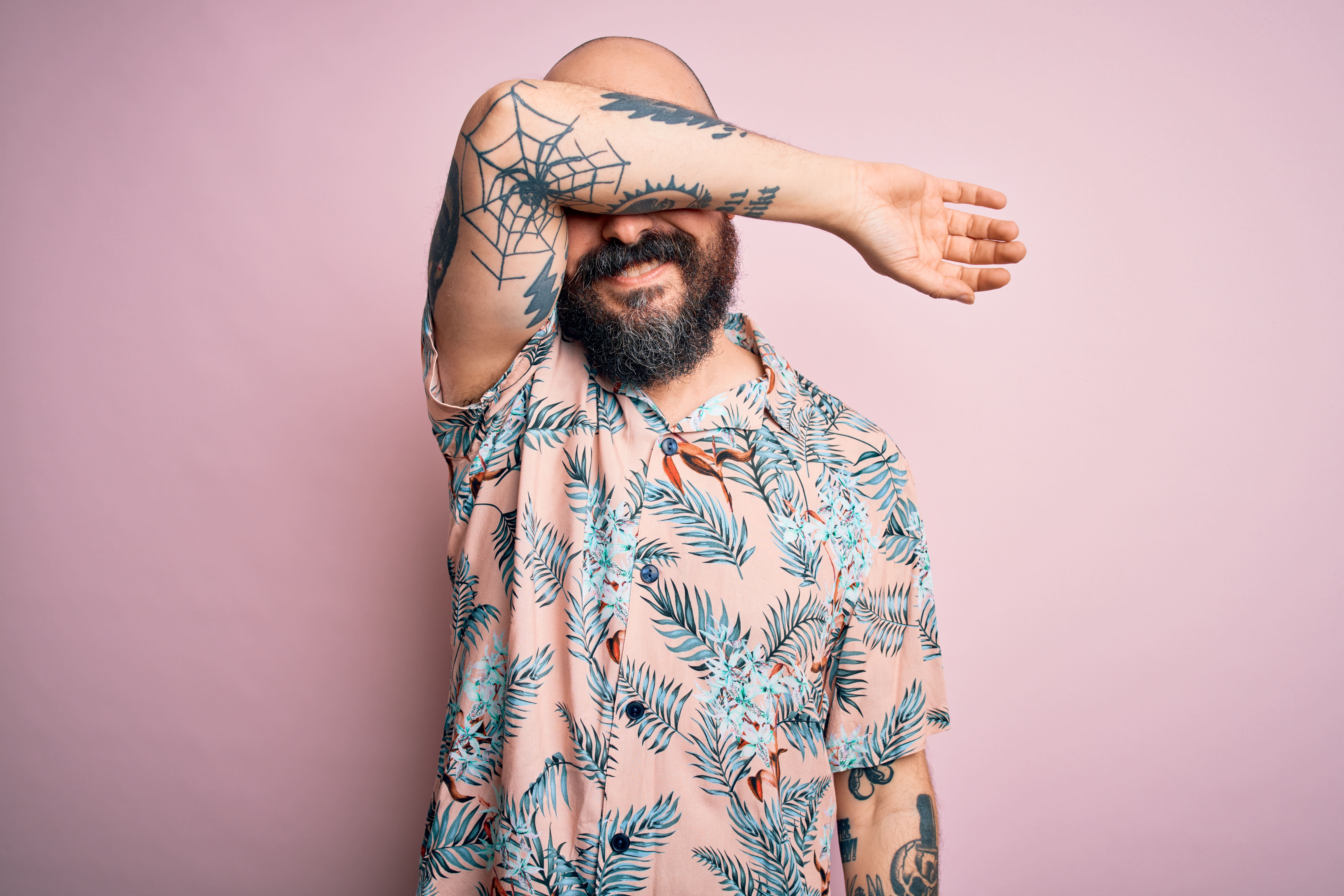 Man with tattooed arm | Shutterstock