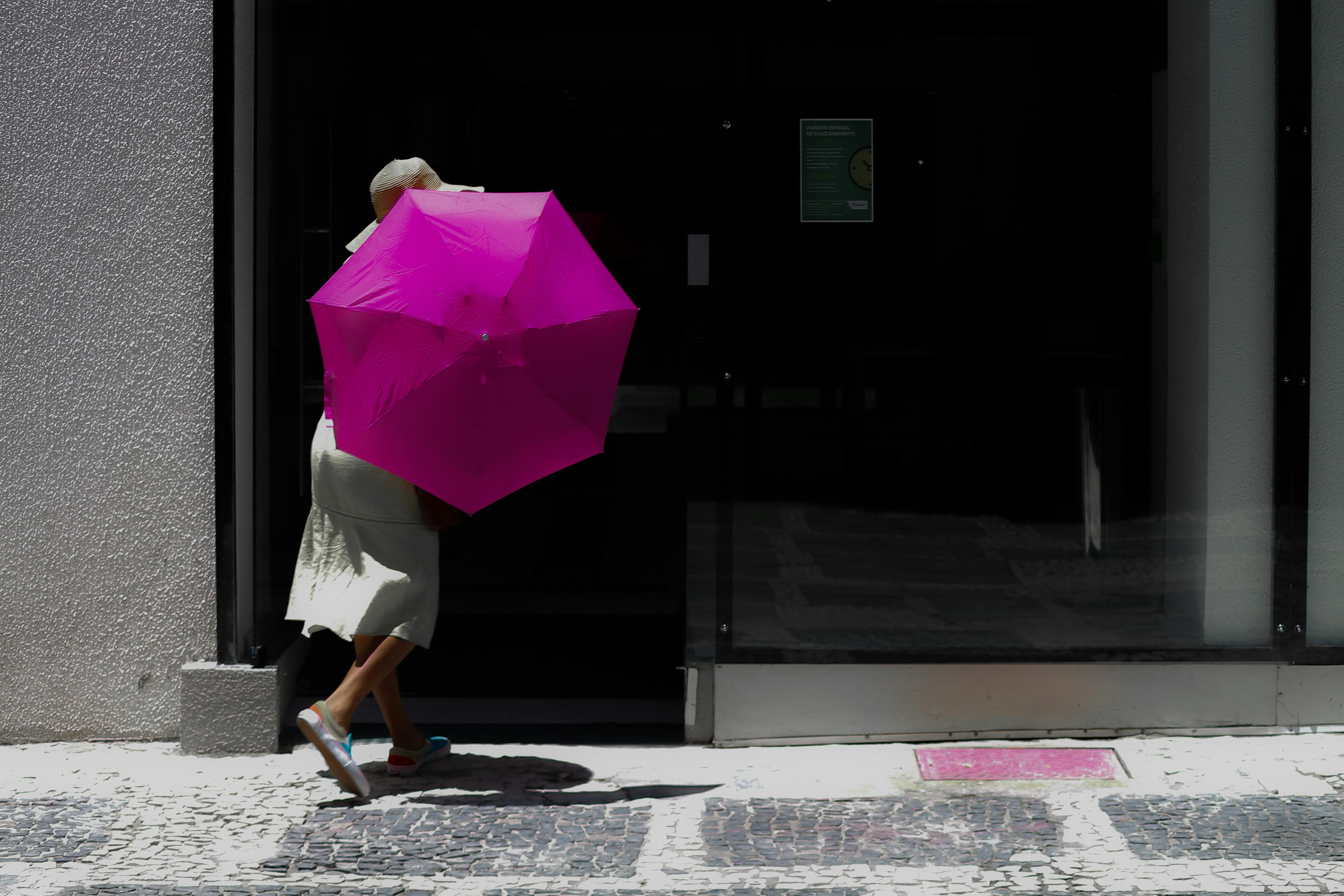 A person with a pink umbrella | Source: Pexels
